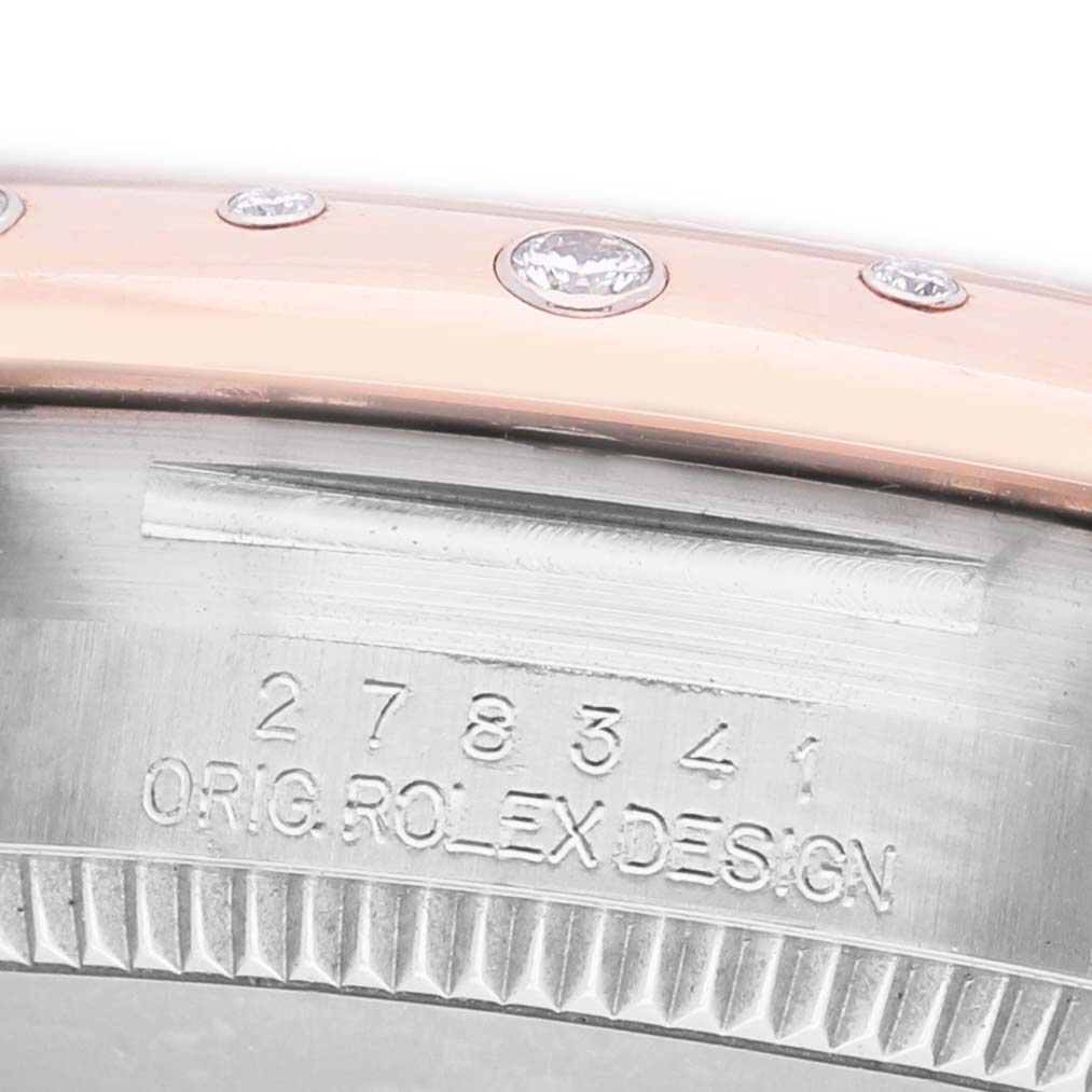 The image shows a close-up side view of a Rolex Mid-Size 278341RBR Women's Stainless Steel Pink Dial watch, highlighting the engraved bezel and diamond details.