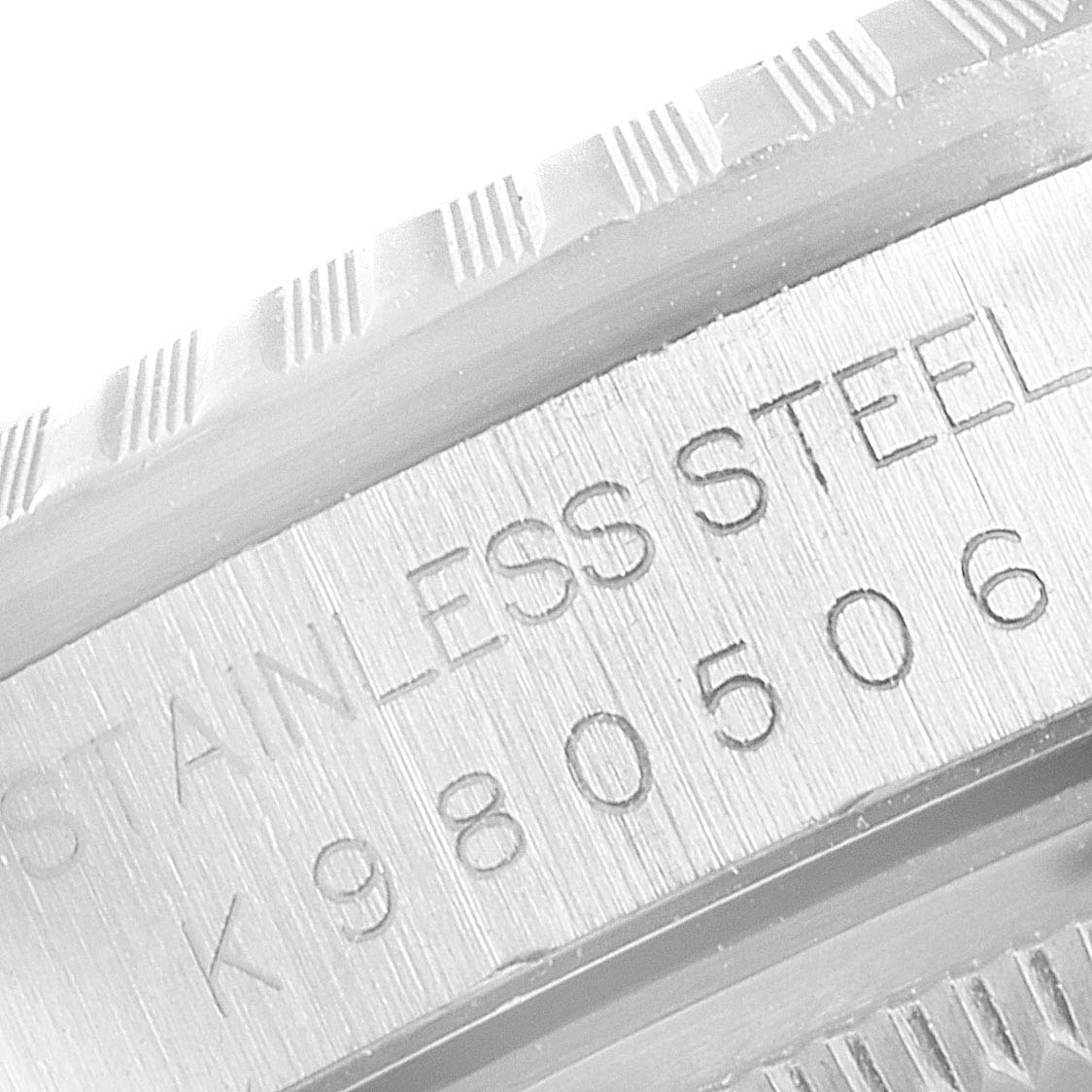 This image shows a close-up of the engraved serial number and "STAINLESS STEEL" marking on the case of a Rolex Datejust 16220 Men
s Stainless Steel Black Dial 16220 Men
s Stainless Steel Black Dial watch.