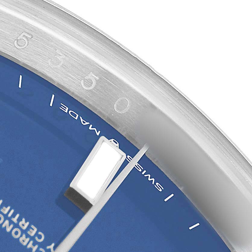 The image shows a close-up of the Rolex Datejust 41 126300 Men's Stainless Steel Blue Dial, highlighting the blue dial, a rectangular hour marker, and part of the bezel.