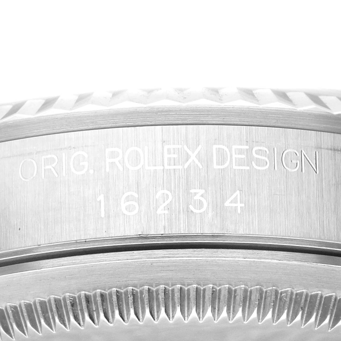 The image shows a close-up of the case back and edge of the bezel of a Rolex Datejust 16234 Men's Stainless Steel Black Dial 16234 Men's Stainless Steel Black Dial model with the design number 16234.