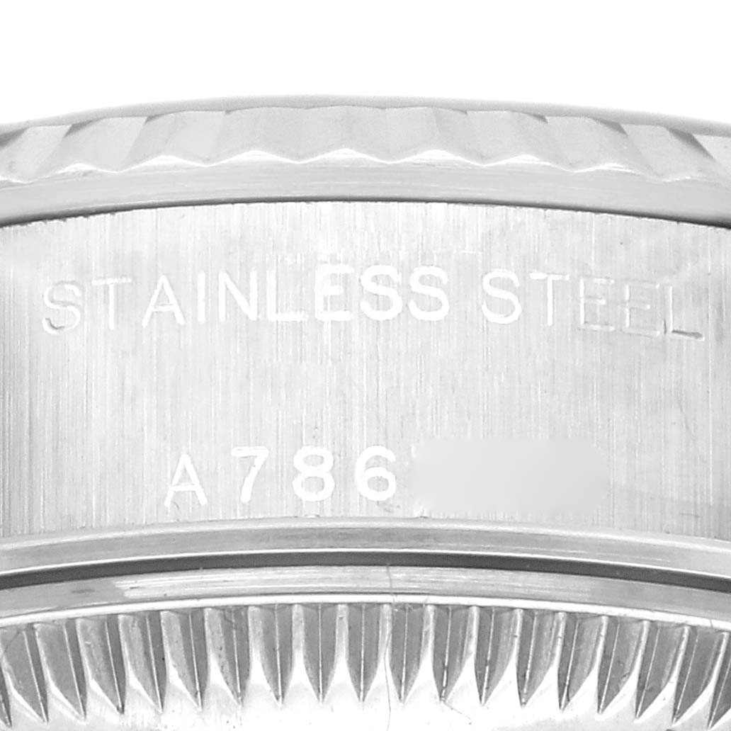 The image shows an up-close view of the side of a Rolex Datejust 79174 Women's Stainless Steel Blue Dial 79174 Women's Stainless Steel Blue Dial watch, highlighting its stainless steel material and serial number.