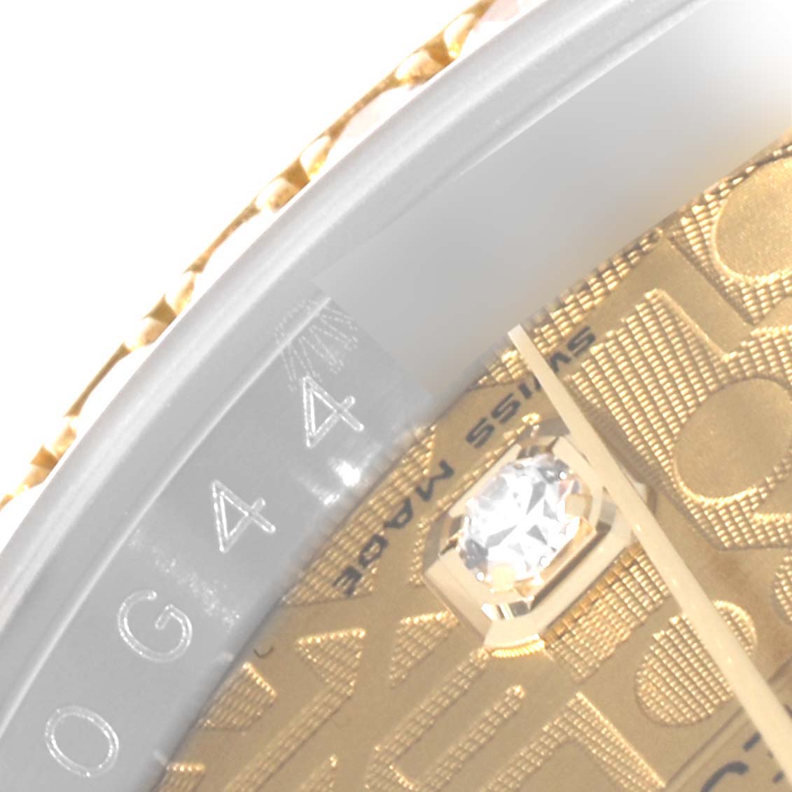 The image shows a close-up angle of the dial and bezel of a Rolex Datejust 116243 Men's Steel and Gold (two tone) Champagne Dial 116243 Men's Steel and Gold (two tone) Champagne Dial, highlighting the gold dial and diamond hour marker.