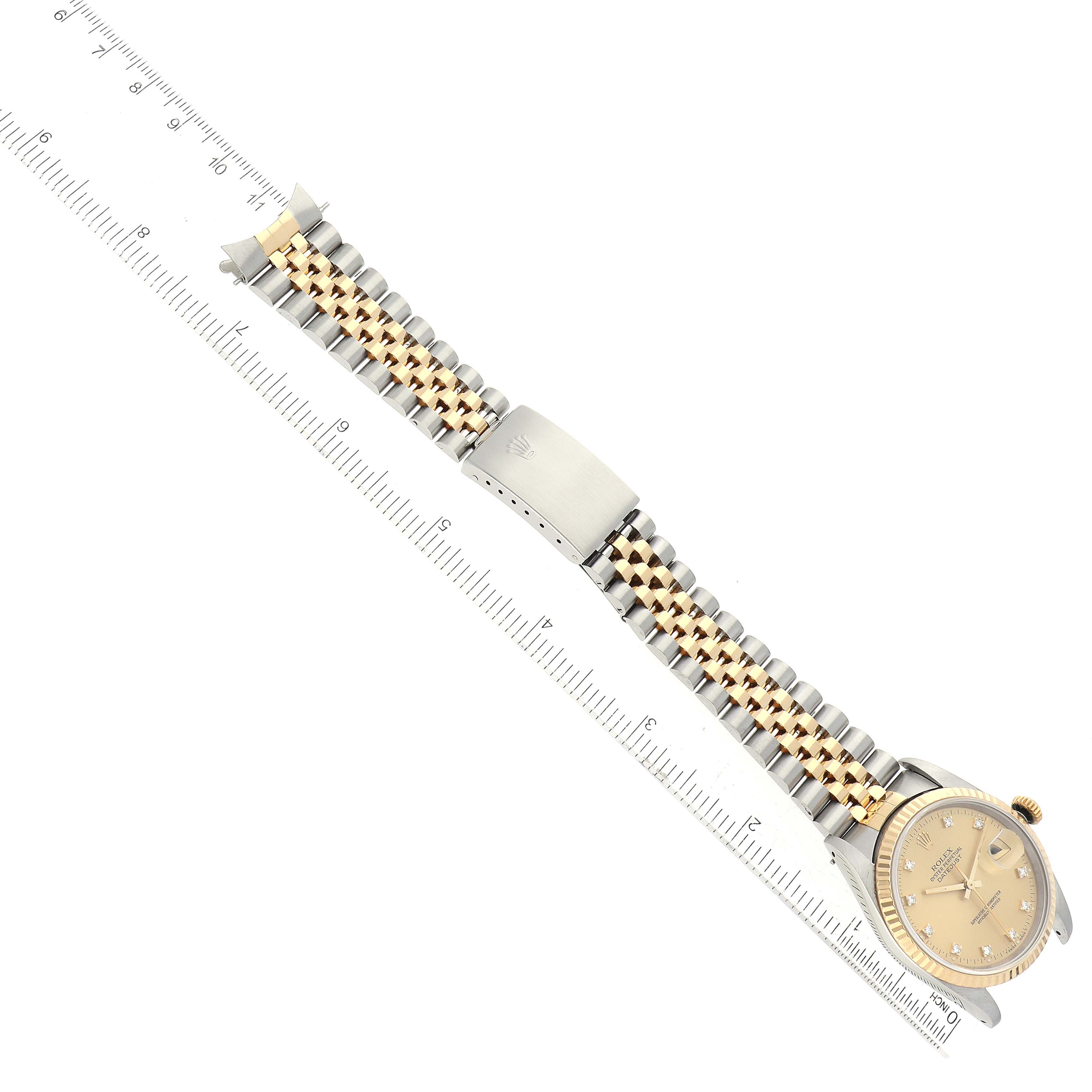 The Rolex Datejust 16233 Men's Steel and Gold (two tone) Champagne Dial 16233 Men's Steel and Gold (two tone) Champagne Dial watch is shown from an overhead angle, displaying the entire strap, dial, clasp, and part of the crown.