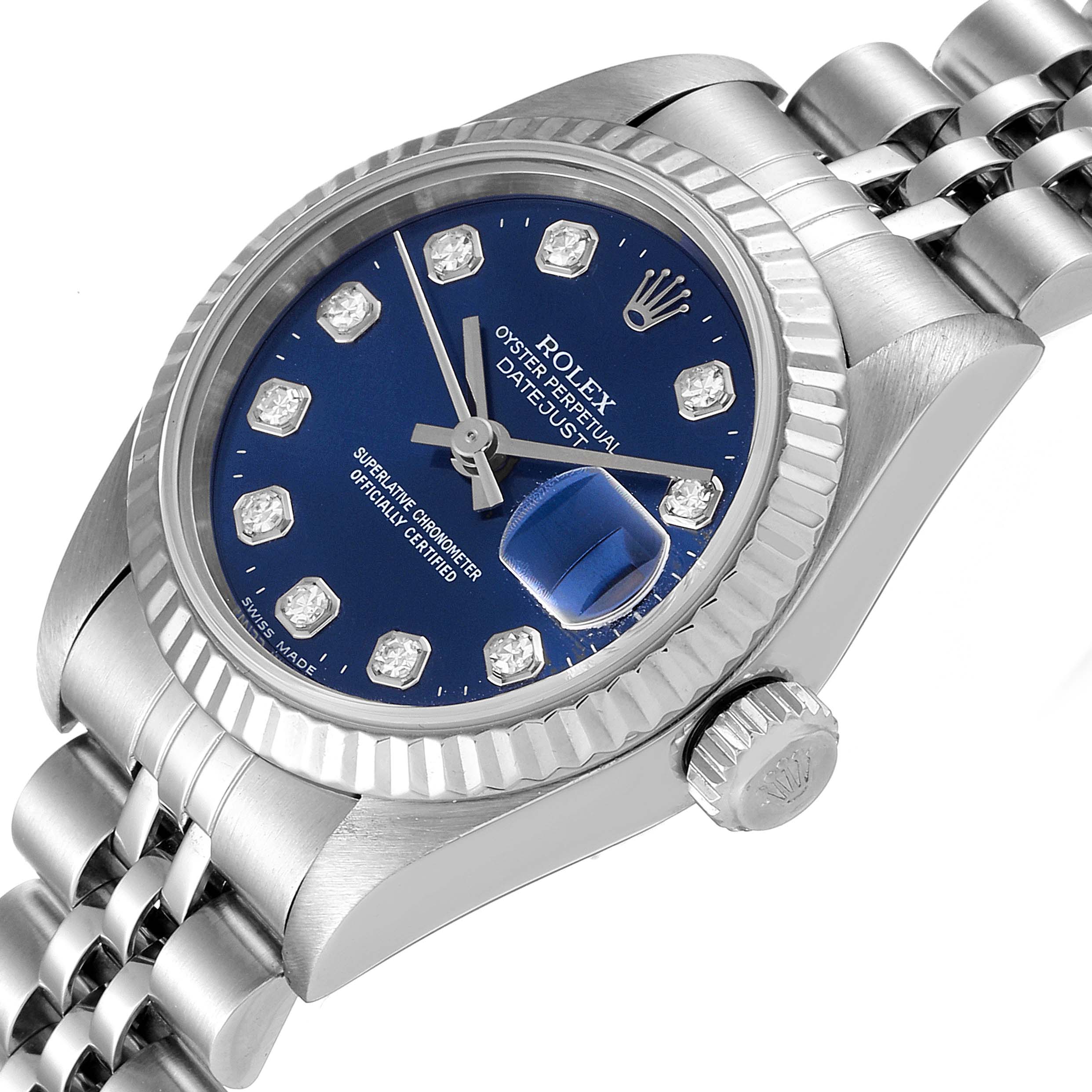 The image shows a Rolex Datejust 69174 Women
s Stainless Steel Blue Dial 69174 Women
s Stainless Steel Blue Dial watch at an angled view highlighting the blue dial, diamond markers, fluted bezel, and part of the bracelet.