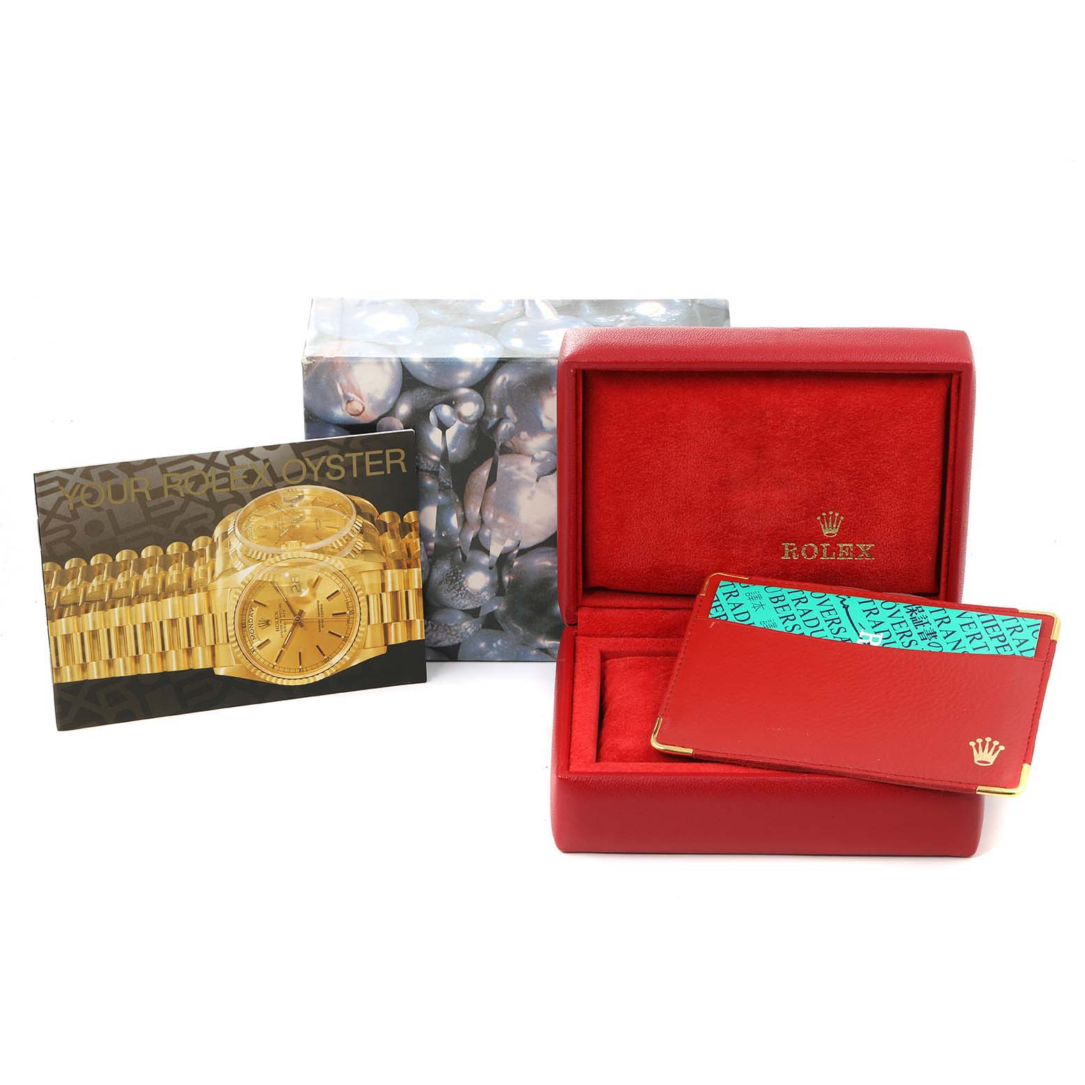 The image shows a Rolex Datejust 69174 Women
s Stainless Steel Blue Dial 69174 Women
s Stainless Steel Blue Dial watch box and accessories, including a brochure and a cardholder, all at eye level.