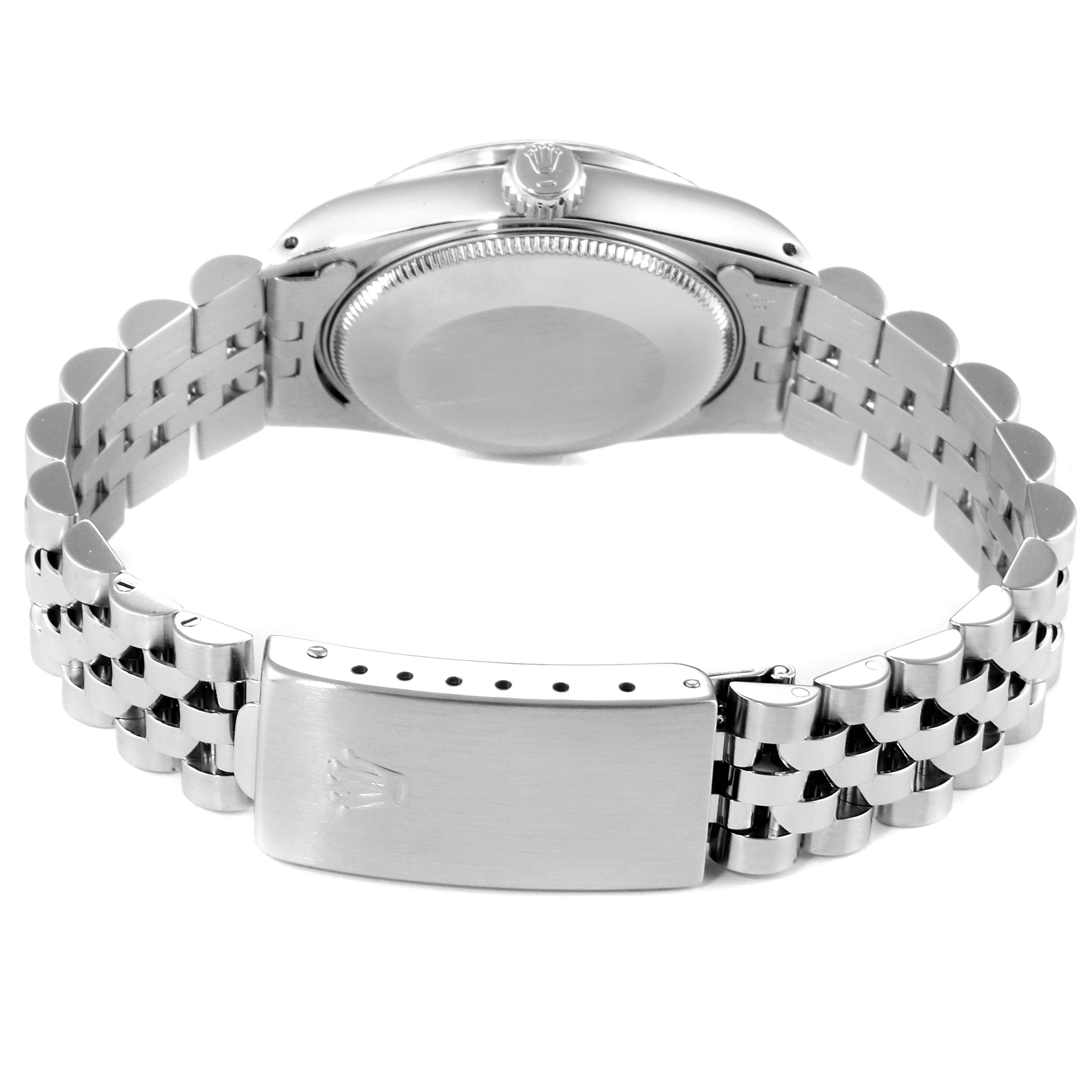 The image shows the back view of a Mid-Size Rolex watch, focusing on the case, crown, and Jubilee bracelet with clasp.