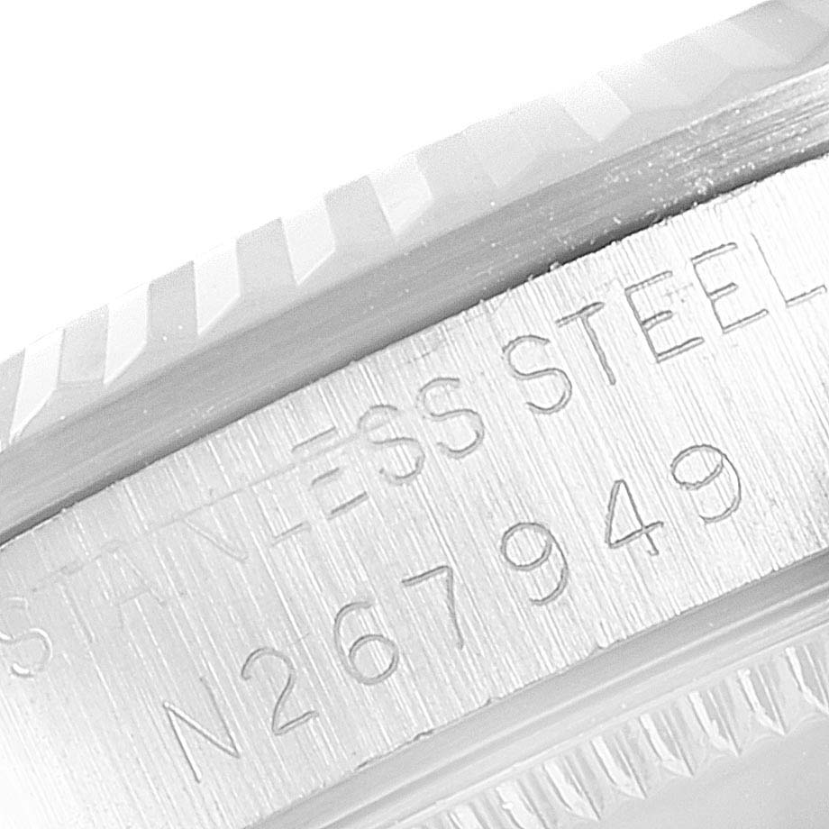 This close-up image of the Mid-Size Rolex watch shows the engraved stainless steel case and serial number.
