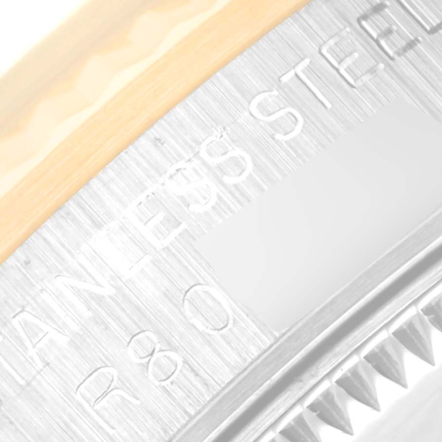 This close-up image shows the edge and engravings of the case back of a Rolex Mid-Size 68273 Women's Steel and Gold (two tone) Black Dial 68273 Women's Steel and Gold (two tone) Black Dial model watch.