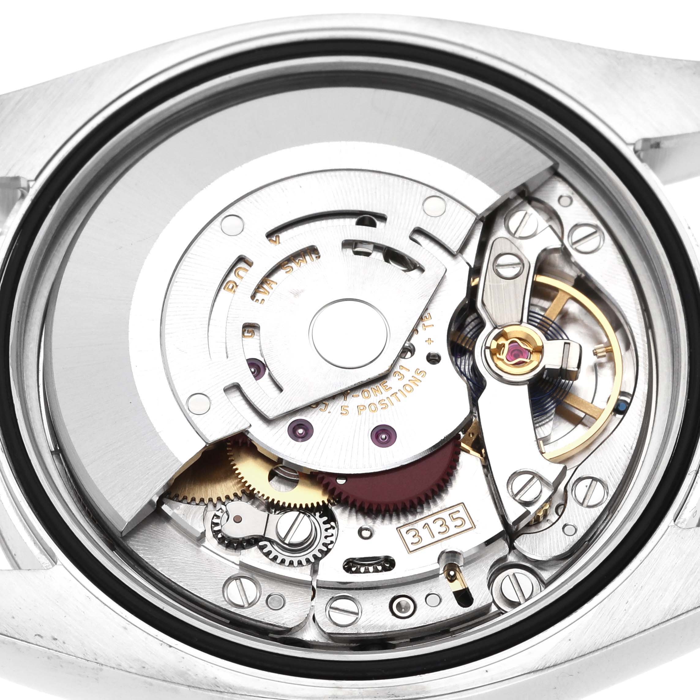 This is an internal view of the Rolex Datejust 116234 Men's Stainless Steel Black Dial 116234 Men's Stainless Steel Black Dial watch showing its intricate mechanical movement components.