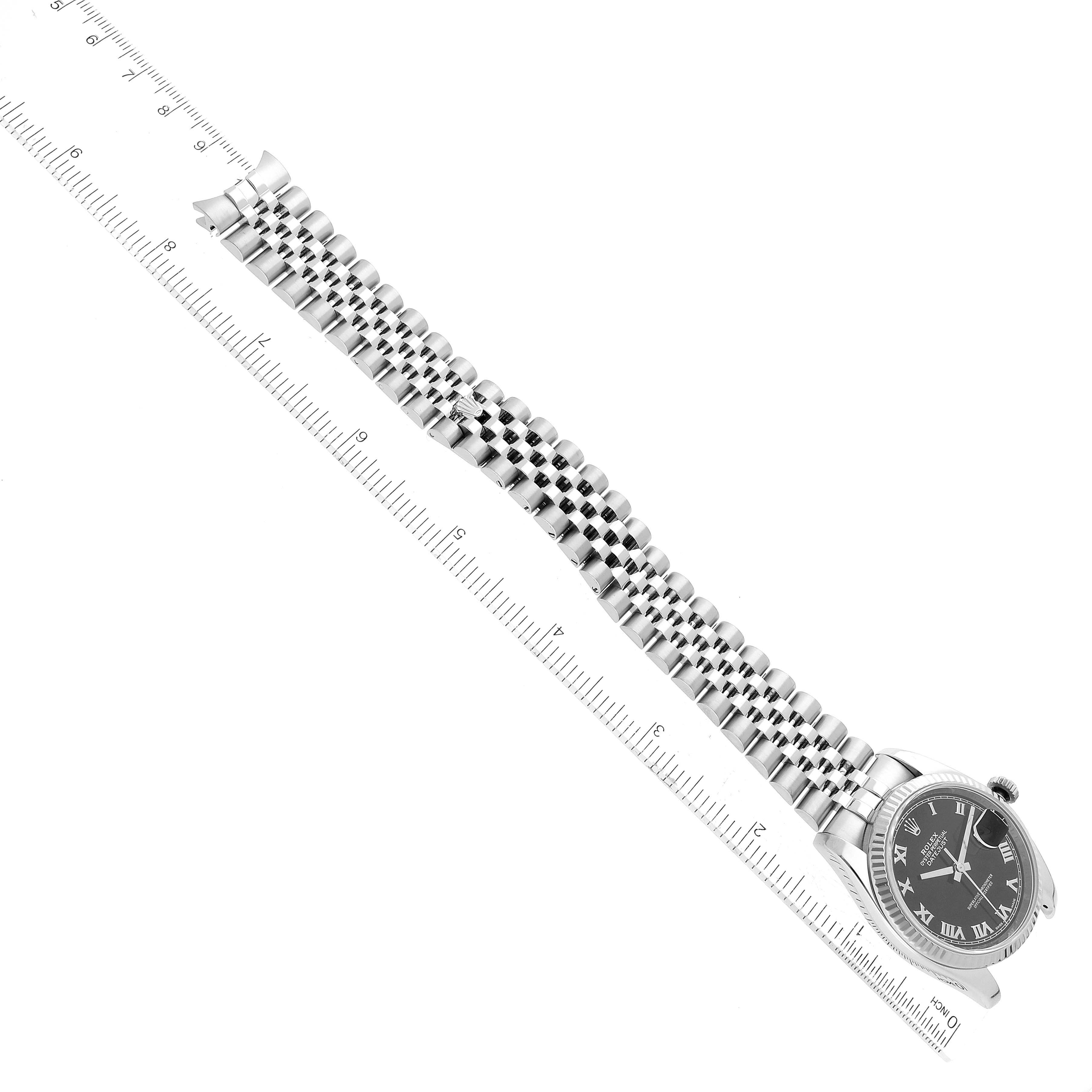 The image shows a Rolex Datejust 116234 Men's Stainless Steel Black Dial 116234 Men's Stainless Steel Black Dial watch at an angled top-down view, highlighting the watch face and stainless steel bracelet next to a ruler.