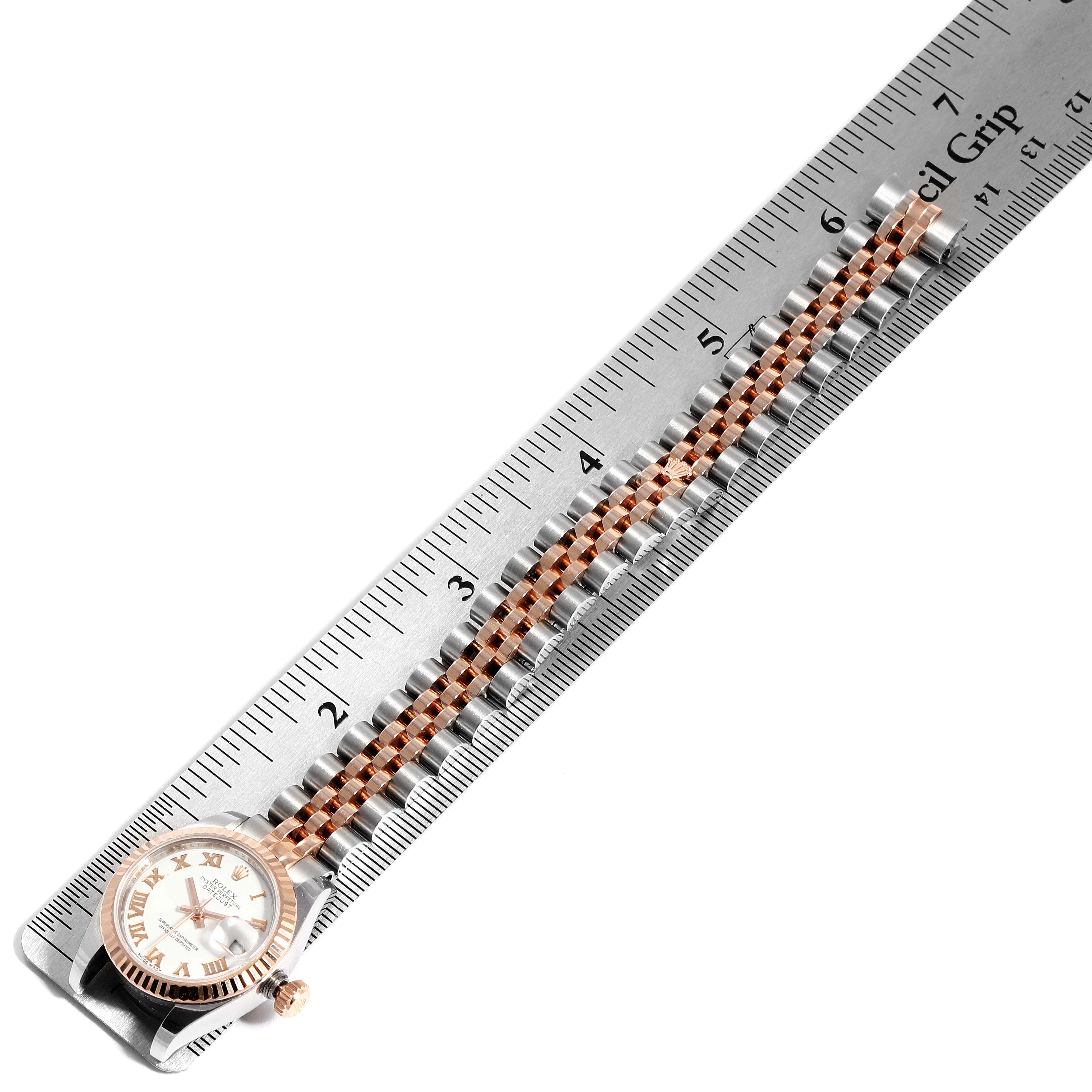 The image shows a Rolex Datejust 179171 Women
s Steel and Gold (two tone) White Dial 179171 Women
s Steel and Gold (two tone) White Dial watch laid flat next to a ruler, highlighting its band length and dial.