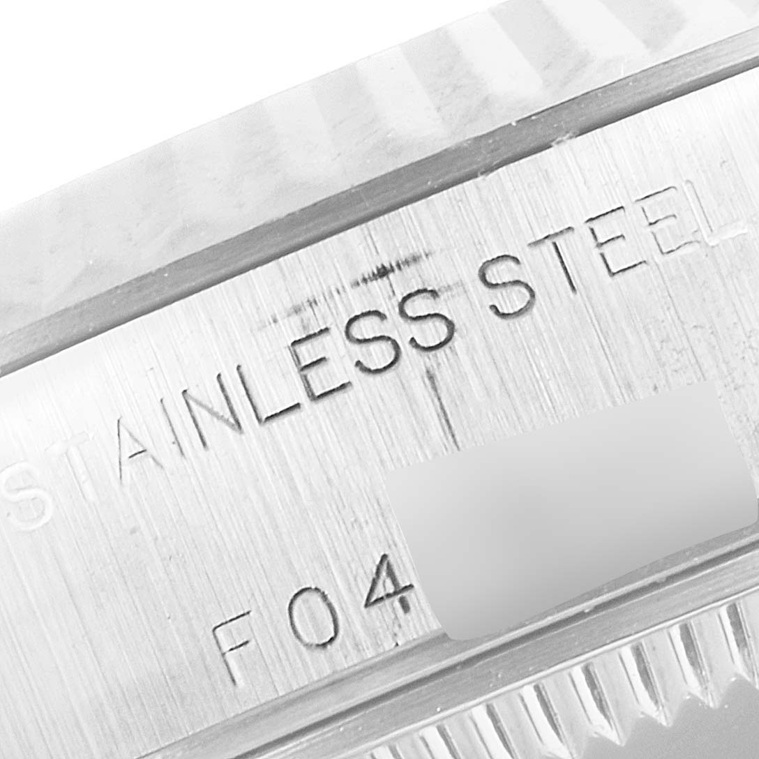 This image shows a close-up of the case side of the Rolex Datejust 79174 Women
s Stainless Steel Mother of Pearl Dial 79174 Women
s Stainless Steel Mother of Pearl Dial, highlighting the "STAINLESS STEEL" engraving.