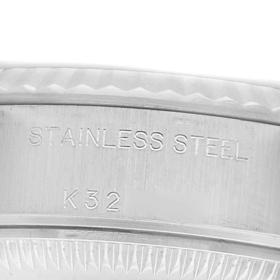 The image shows a close-up of the case back edge of a Rolex Datejust 79174 Women
s Stainless Steel Pink Dial 79174 Women
s Stainless Steel Pink Dial, highlighting the stainless steel engraving.