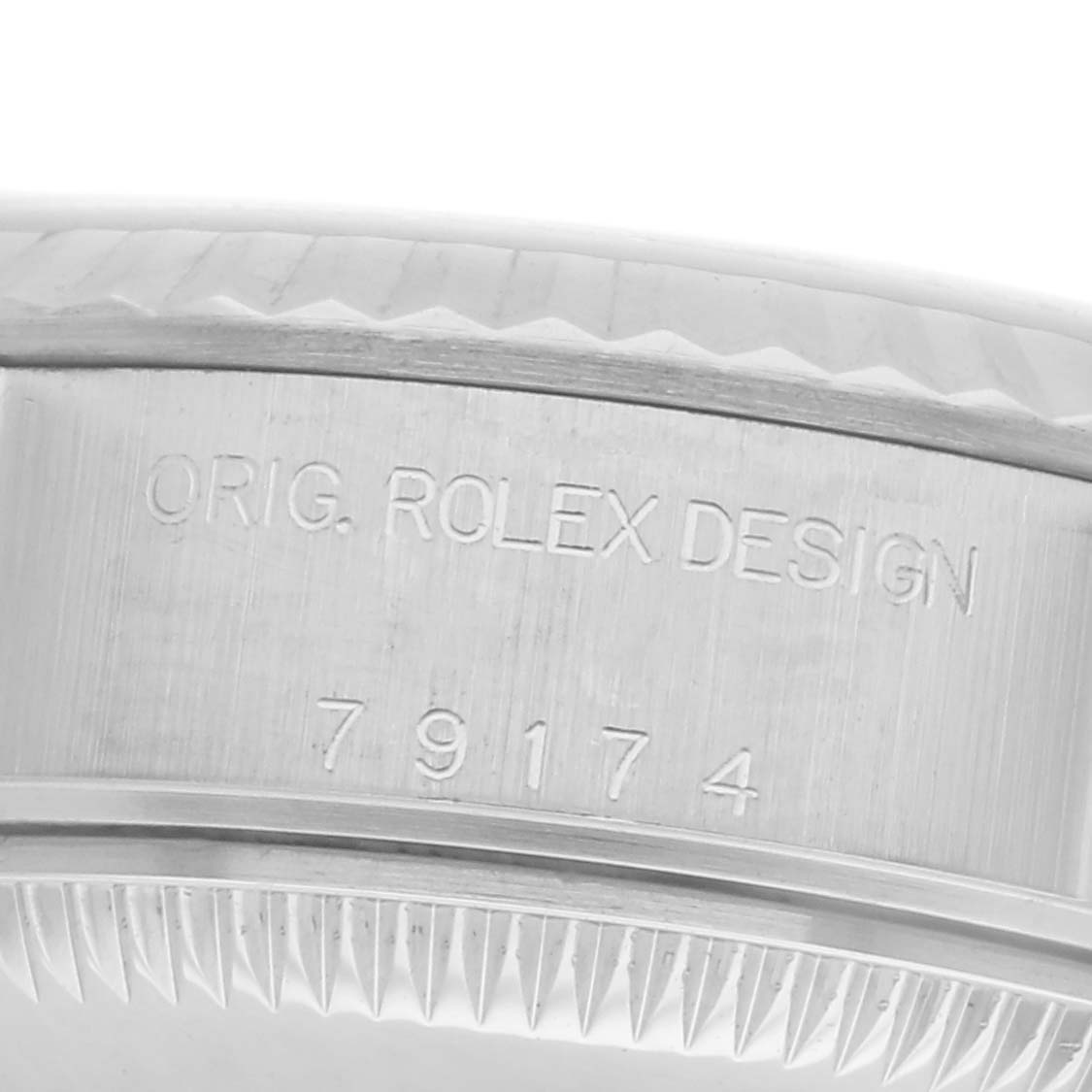 The image shows the side engraving on the casing of a Rolex Datejust 79174 Women
s Stainless Steel Pink Dial 79174 Women
s Stainless Steel Pink Dial watch.