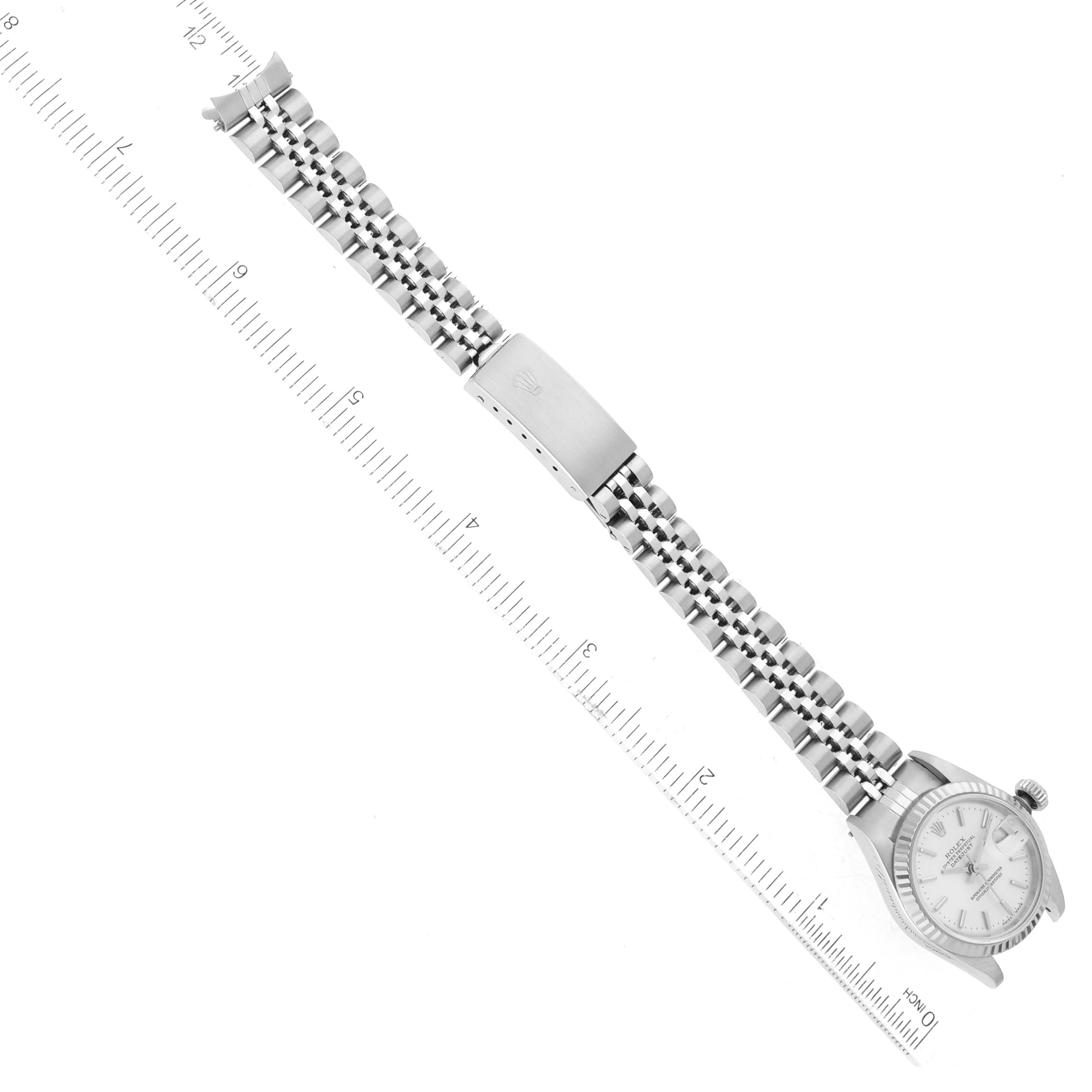 The image shows a Rolex Datejust 79174 Women's Stainless Steel Silver Dial 79174 Women's Stainless Steel Silver Dial watch positioned flat, with a focus on the full bracelet and clasp, alongside a ruler for scale.