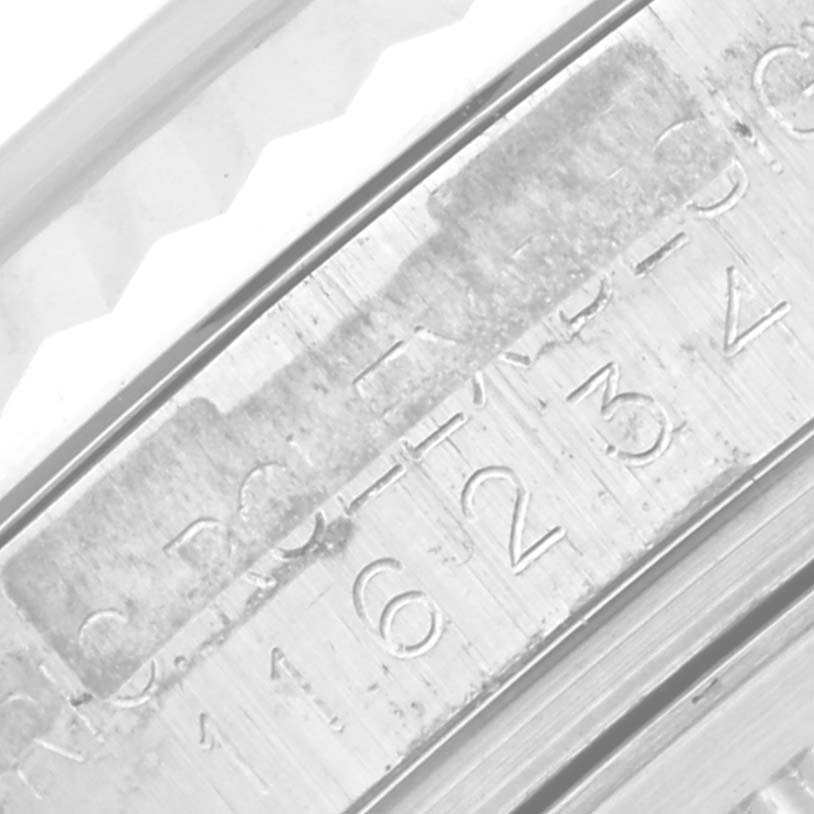 The image shows a close-up of the engraving on the inner bezel of a Rolex Datejust 116234 Men's Stainless Steel Silver Dial 116234 Men's Stainless Steel Silver Dial watch.