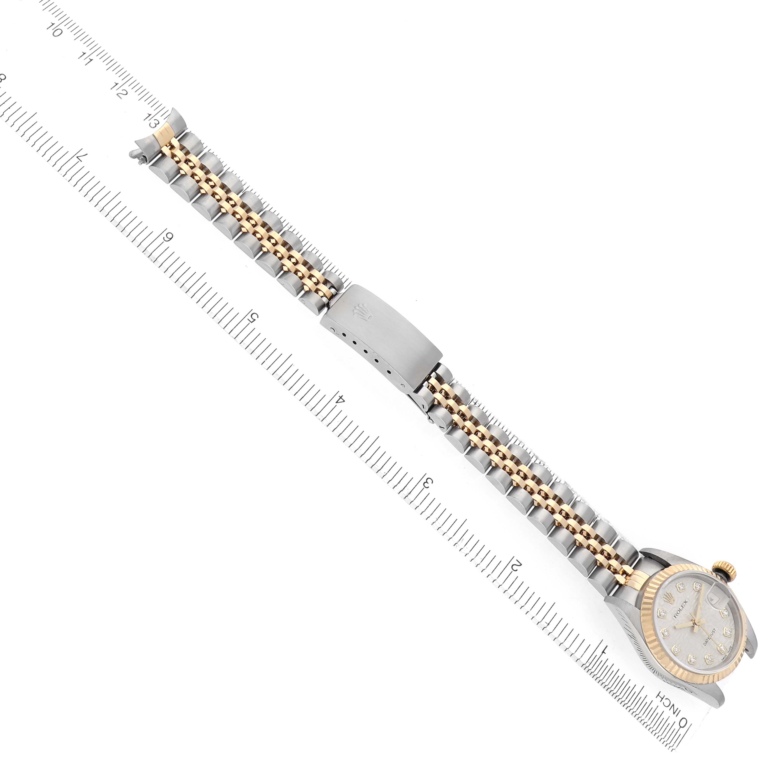 The Rolex Datejust 79173 Women
s Steel and Gold (two tone) Silver Dial 79173 Women
s Steel and Gold (two tone) Silver Dial watch is shown from a top-down angle, highlighting the bracelet, clasp, and face.