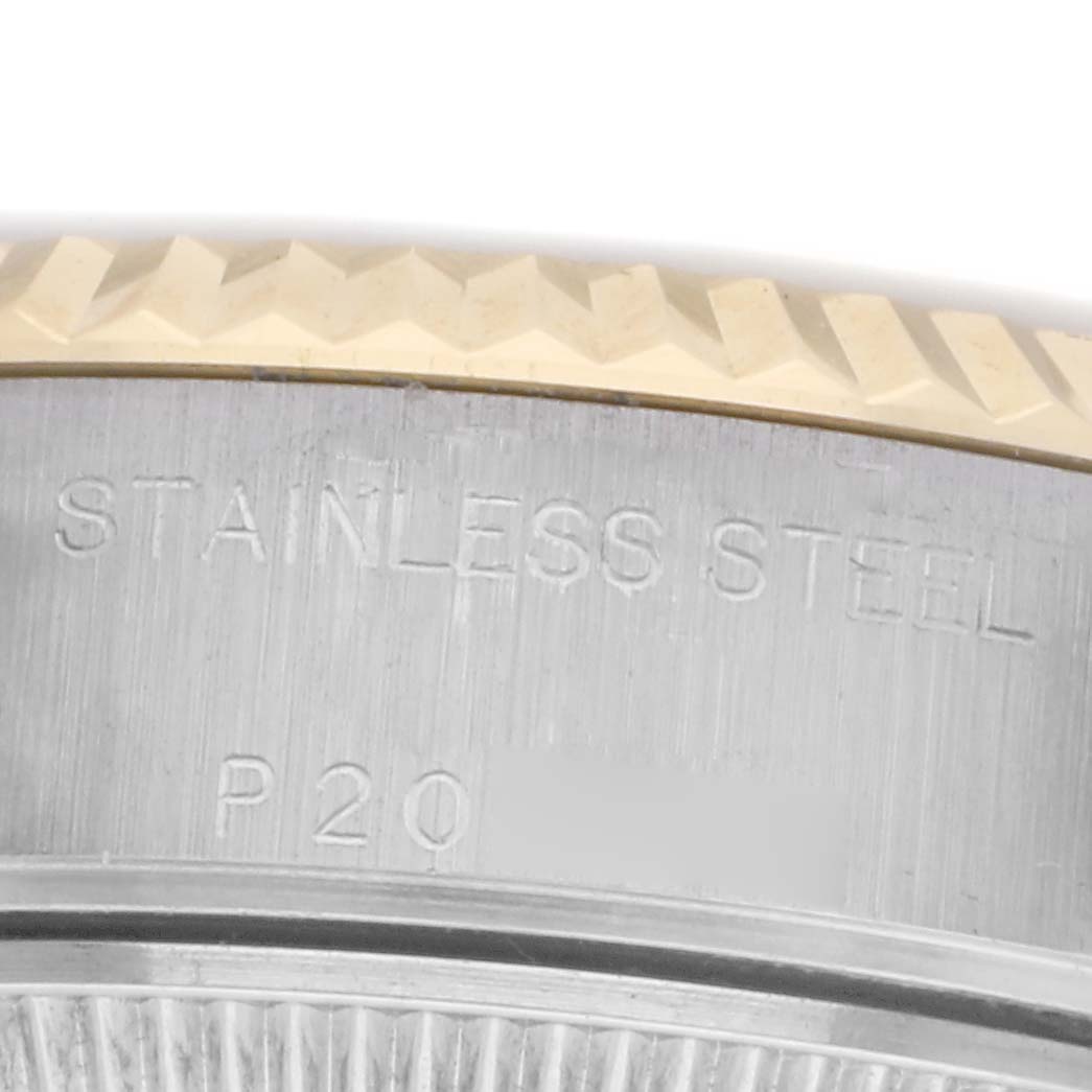 The image shows a close-up of the side of a Rolex Datejust 79173 Women
s Steel and Gold (two tone) Silver Dial 79173 Women
s Steel and Gold (two tone) Silver Dial, highlighting the stainless steel engraving and knurled bezel edge.