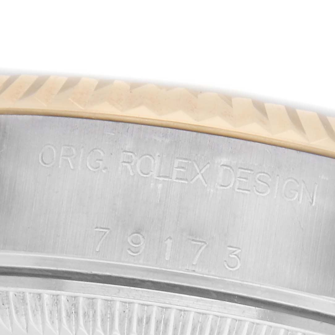 The image shows the side engraving on the case of a Rolex Datejust 79173 Women
s Steel and Gold (two tone) Silver Dial 79173 Women
s Steel and Gold (two tone) Silver Dial, featuring the model number and "Orig. Rolex Design."