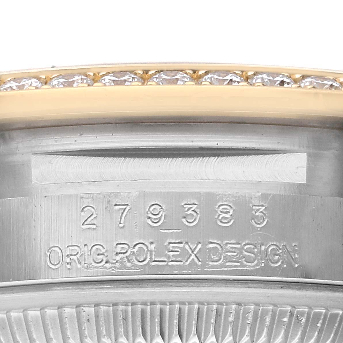 The image shows a close-up of the serial number engraving and part of the diamond bezel on a Rolex Datejust 279383 Women's Steel and Gold (two tone) Champagne Dial 279383 Women's Steel and Gold (two tone) Champagne Dial watch.