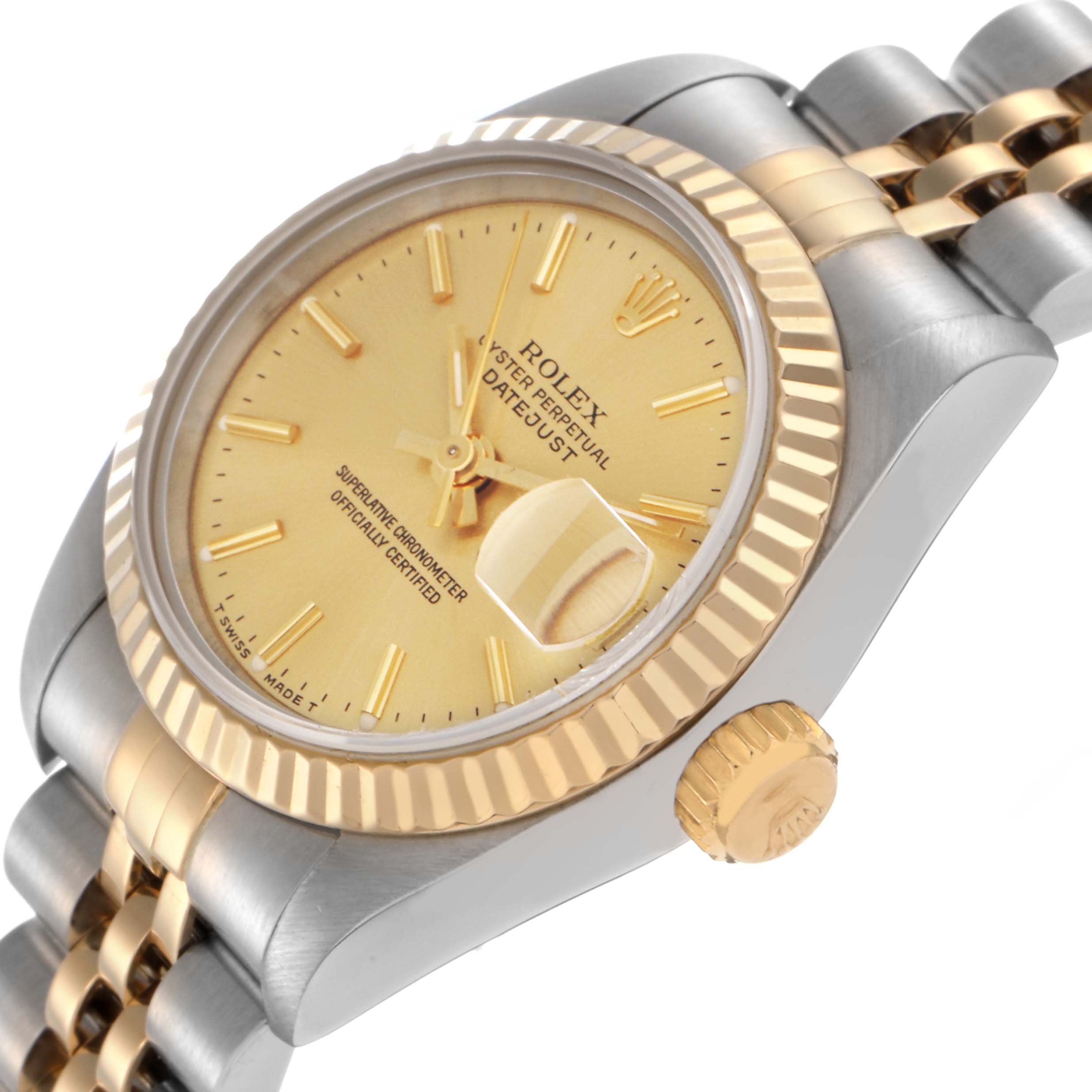 The Rolex Datejust 69173 Women
s Steel and Gold (two tone) Champagne Dial 69173 Women
s Steel and Gold (two tone) Champagne Dial watch is shown at a tilted angle, featuring its gold dial, fluted bezel, and two-tone Jubilee bracelet.