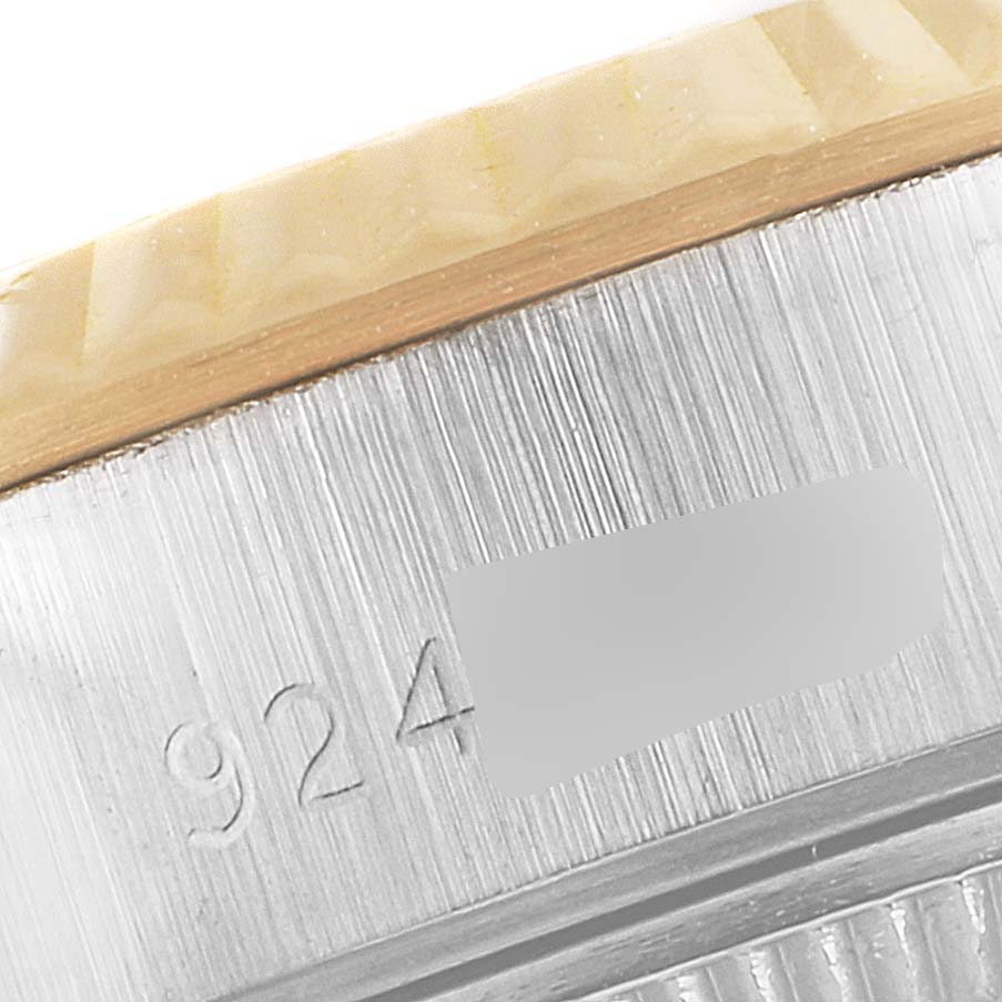 This image shows a close-up of the casing edge of a Rolex Datejust 69173 Women
s Steel and Gold (two tone) Mother of Pearl Dial 69173 Women
s Steel and Gold (two tone) Mother of Pearl Dial watch, specifically the bezel and part of the engraving.