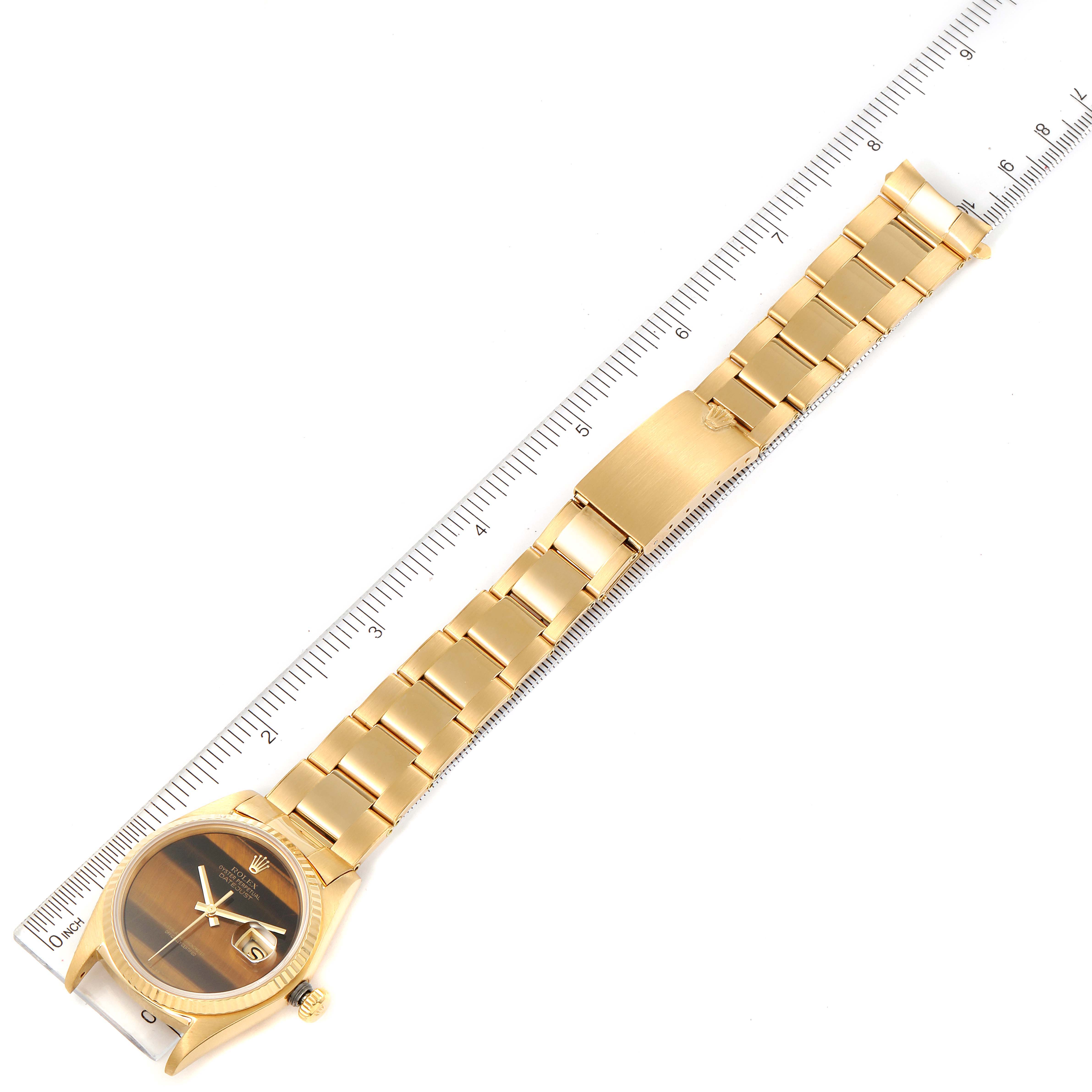 The image shows a top-down view of a Rolex President 16018 Men's Yellow Gold Brown Dial 16018 Men's Yellow Gold Brown Dial model watch, displaying the watch face, bracelet, and clasp next to a ruler.