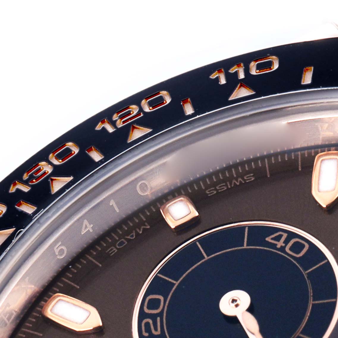 The image shows a close-up of the bezel and part of the dial of a Rolex Daytona 116515 Men's Rose Gold Brown Dial 116515 Men's Rose Gold Brown Dial, highlighting the tachymetric scale.