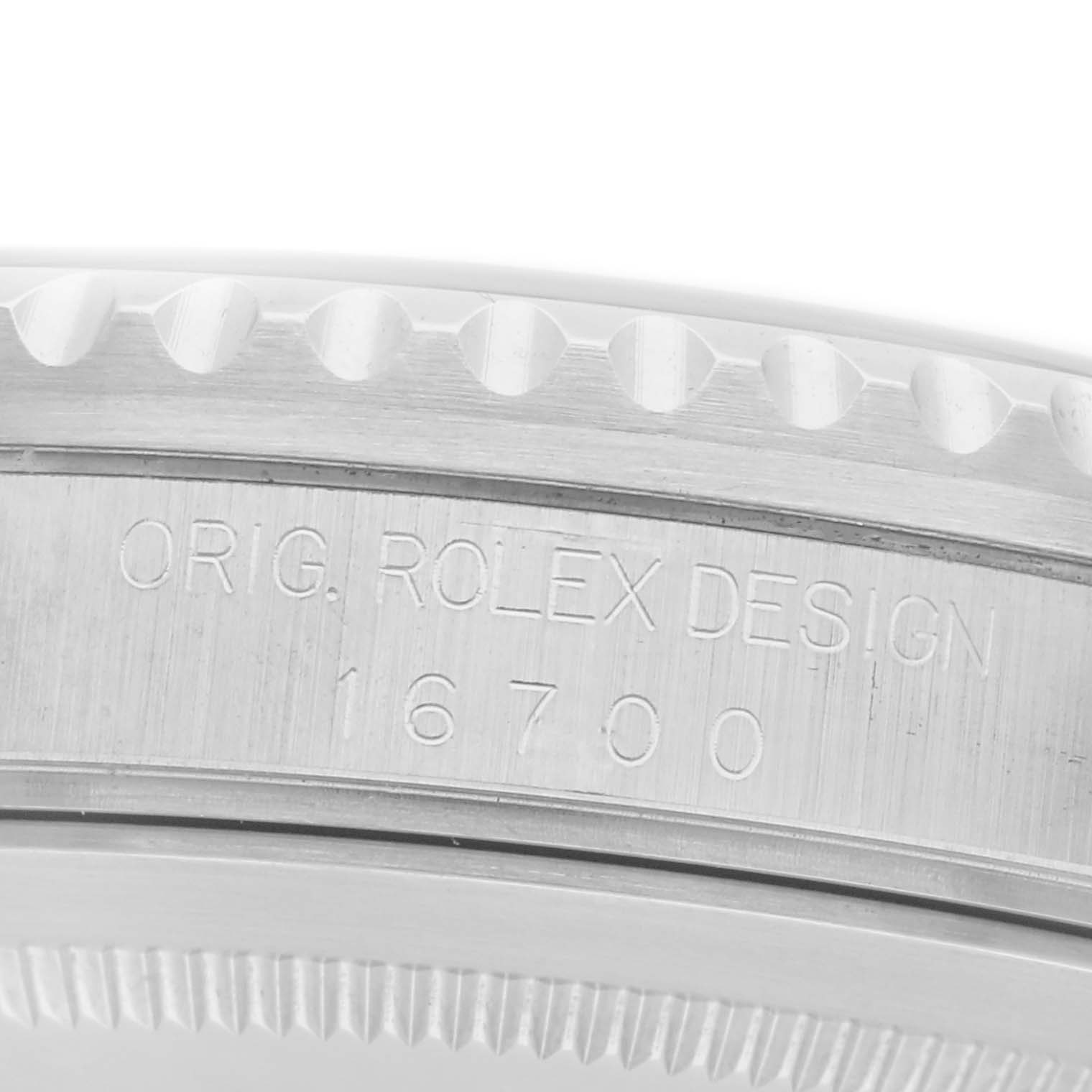 The image shows an angled close-up of the case side of a Rolex GMT-Master 16700 Men
s Stainless Steel Black Dial 16700 Men
s Stainless Steel Black Dial, highlighting the engraved model number 16700.