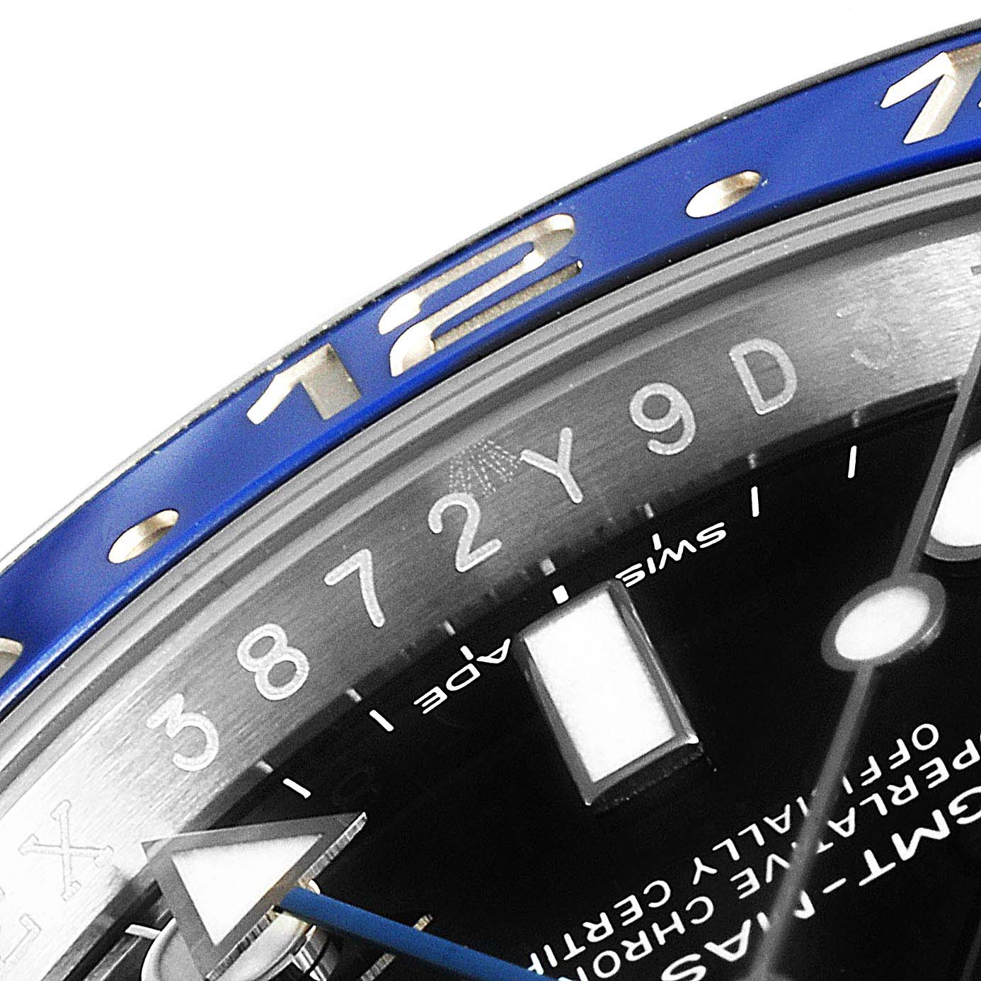 This image shows a close-up of the bezel and dial of a Rolex GMT-Master 116710  Men
s Stainless Steel Black Dial 116710  Men
s Stainless Steel Black Dial watch, featuring the 12-hour mark and part of the numerals.