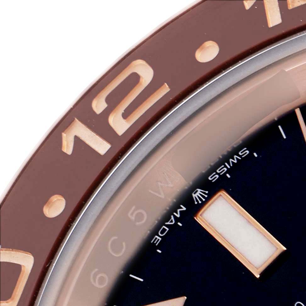 The image shows a close-up of the bezel and part of the dial of a Rolex GMT-Master 126715CHNR Men
s Rose Gold Black Dial 126715CHNR Men
s Rose Gold Black Dial watch with the number "12" visible.