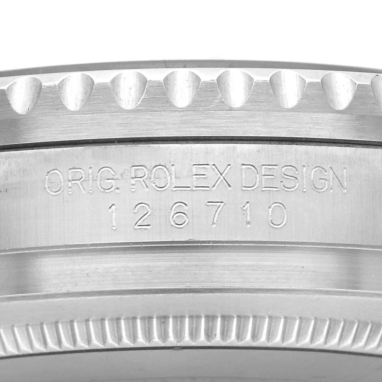 The image shows a close-up side view of the Rolex GMT-Master 126710BLRO Men
s Stainless Steel Black Dial 126710BLRO Men
s Stainless Steel Black Dial
s engraved case edge, featuring design and model number details.