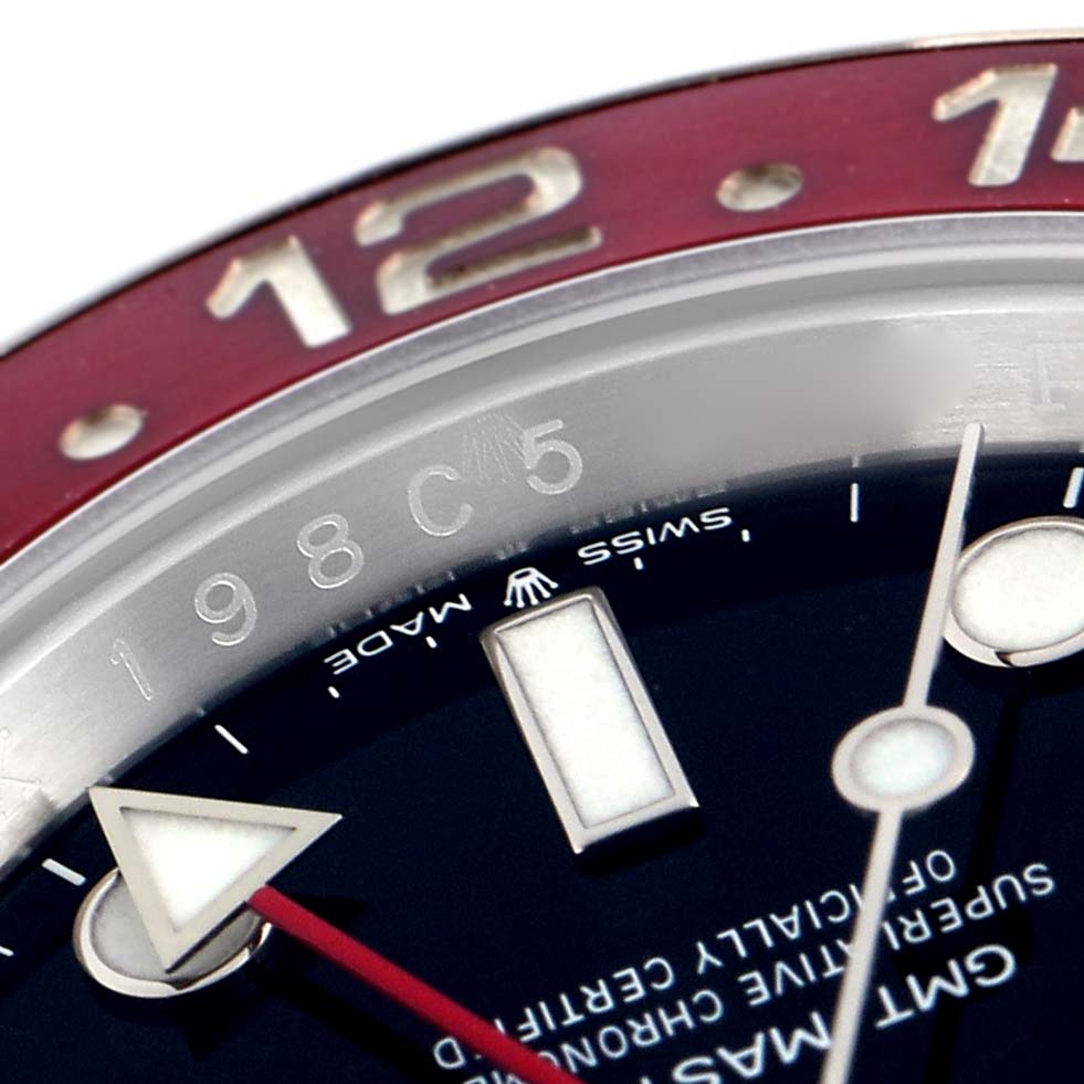 The image shows a close-up of the Rolex GMT-Master 126710BLRO Men
s Stainless Steel Black Dial 126710BLRO Men
s Stainless Steel Black Dial
s bezel, red GMT hand, and part of the dial.