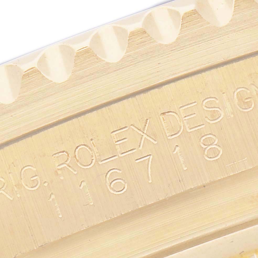 The image shows a close-up of the engraved model number on the side of a Rolex GMT-Master 116718 Men
s Yellow Gold Green Dial 116718 Men
s Yellow Gold Green Dial watch case.