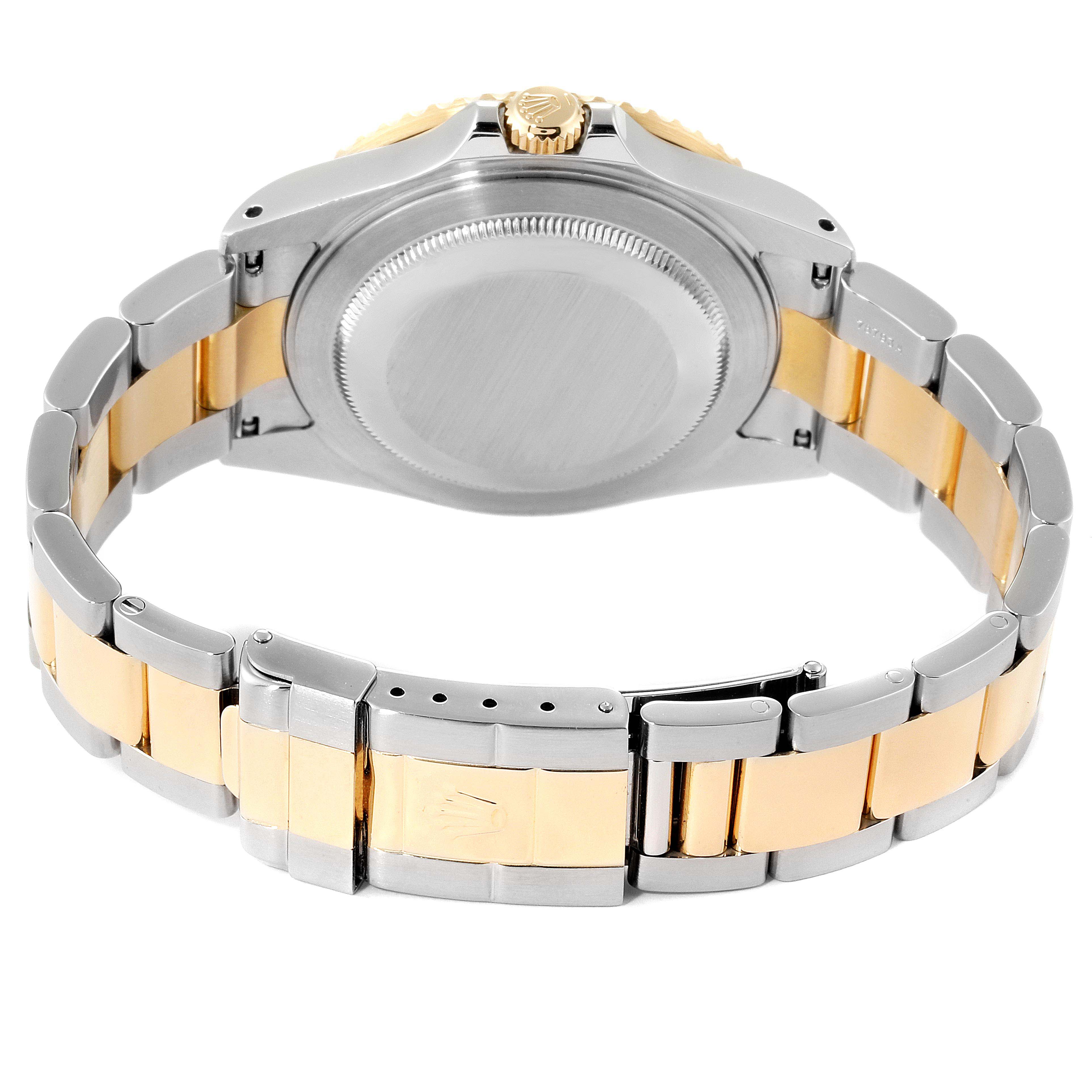 The image shows the back case and bracelet of a Rolex GMT-Master 16713  Men's Steel and Gold (two tone) Black Dial 16713  Men's Steel and Gold (two tone) Black Dial watch, featuring a two-tone stainless steel and gold design.