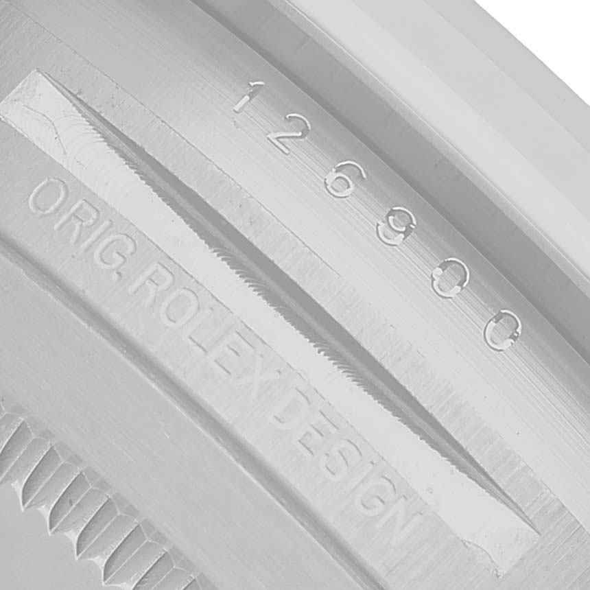 The image shows the edge of the back casing of a Rolex Air-King 126900 Men's Stainless Steel Black Dial, displaying the model number and "ORIG. ROLEX DESIGN" engraving.