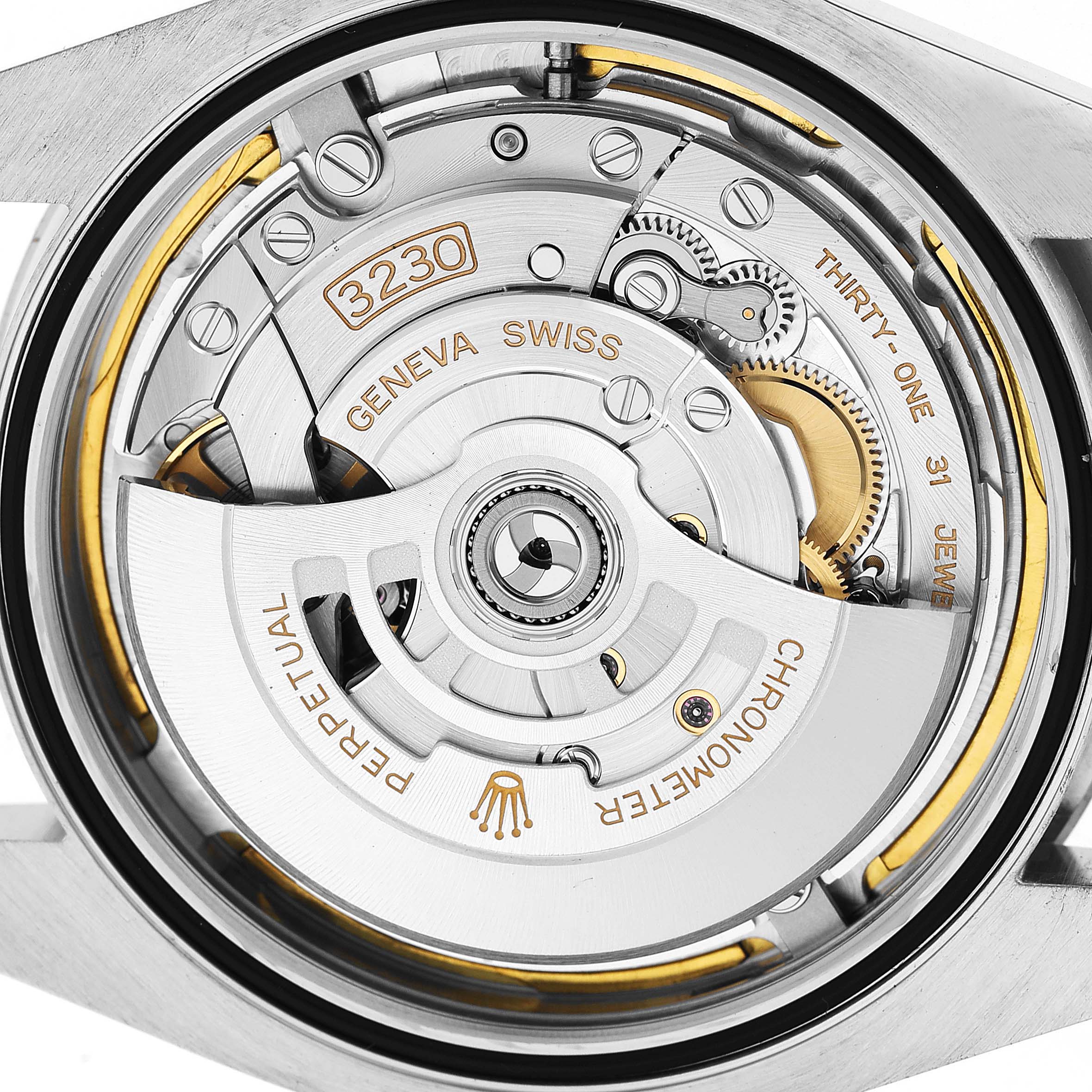 The image shows the movement mechanism of a Rolex Air-King 126900 Men's Stainless Steel Black Dial watch, highlighting the rotor and intricate components.