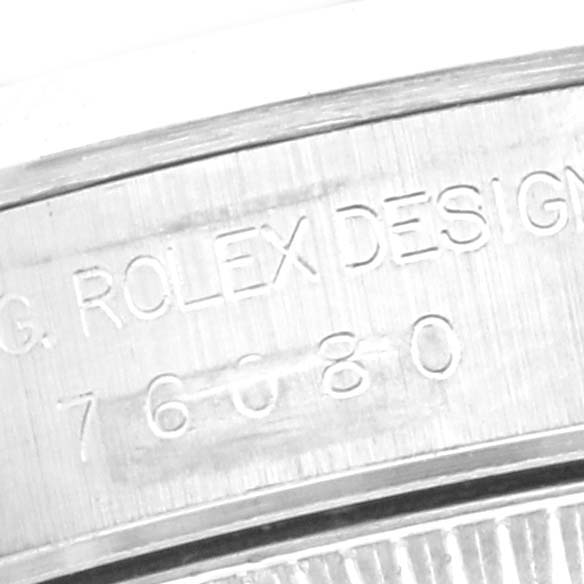 The image shows the side view of the Oyster Perpetual
s case, highlighting the engraved "ROLEX DESIGN" and model number.