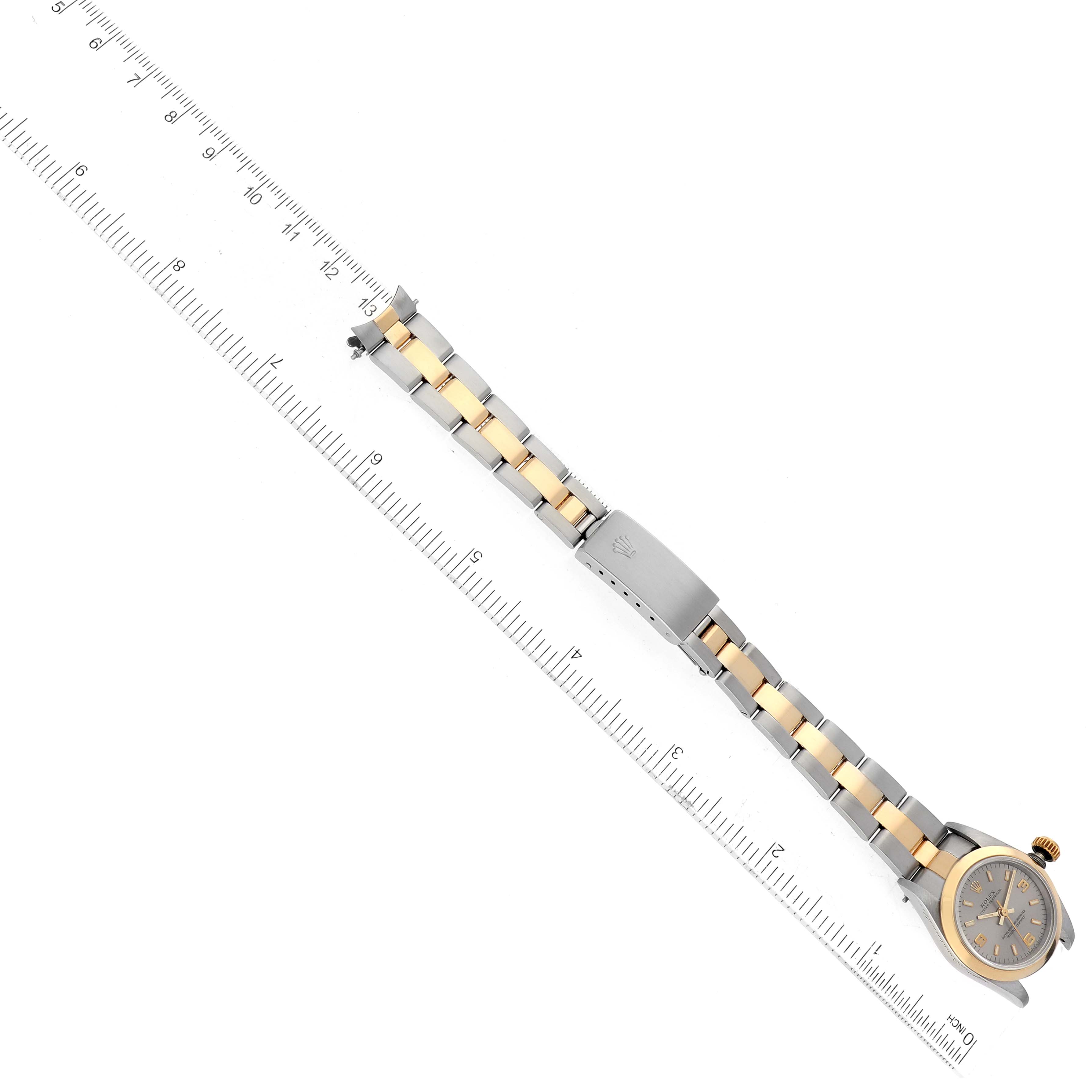 The image shows a top-down view of a Rolex Oyster Perpetual 67183 Women's Steel and Gold (two tone) Grey Dial 67183 Women's Steel and Gold (two tone) Grey Dial watch, including its two-tone bracelet and partially visible dial.