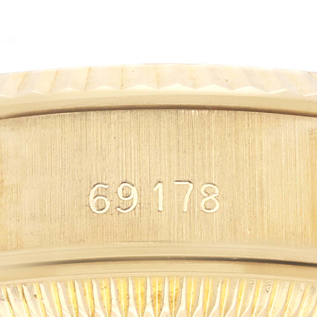 The image shows a close-up of the side of a Rolex President 69178 Women
s Yellow Gold Champagne Dial 69178 Women
s Yellow Gold Champagne Dial watch, highlighting the engraved model number "69178."
