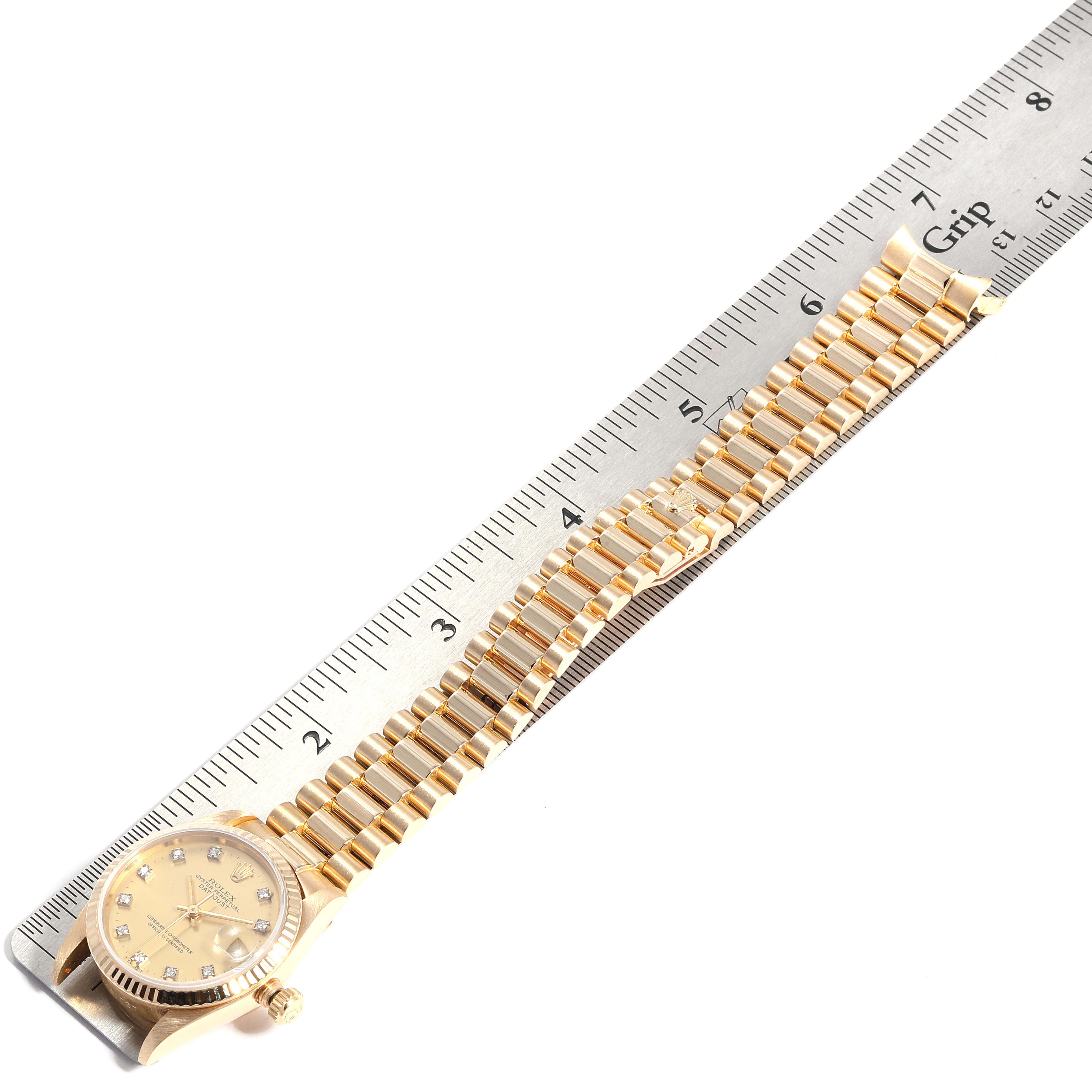 The image shows a Rolex President 68278 Women
s Yellow Gold Champagne Dial 68278 Women
s Yellow Gold Champagne Dial watch laid flat with a ruler measuring its bracelet.
