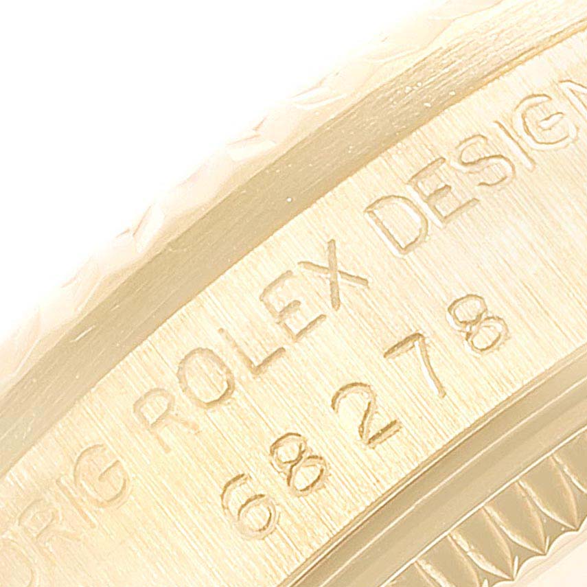This close-up image shows the side engraving of a Rolex President 68278 Women
s Yellow Gold Champagne Dial 68278 Women
s Yellow Gold Champagne Dial model watch.