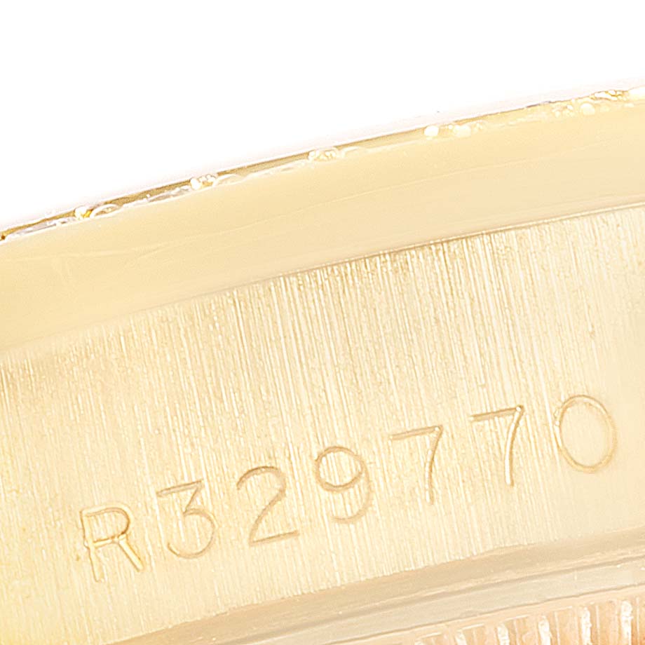 This close-up image shows the engraved serial number on the case of a Rolex President 69038 Women's Yellow Gold Black Dial 69038 Women's Yellow Gold Black Dial model watch.