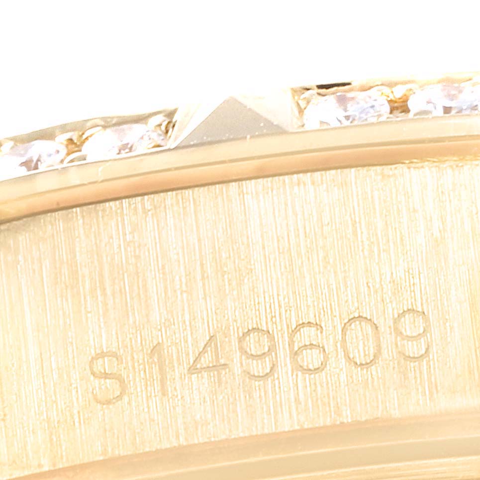 The image shows a close-up of the case back and edge of a Rolex President 69258 Women
s Yellow Gold Champagne Dial 69258 Women
s Yellow Gold Champagne Dial model, highlighting its serial number and gemstone details.