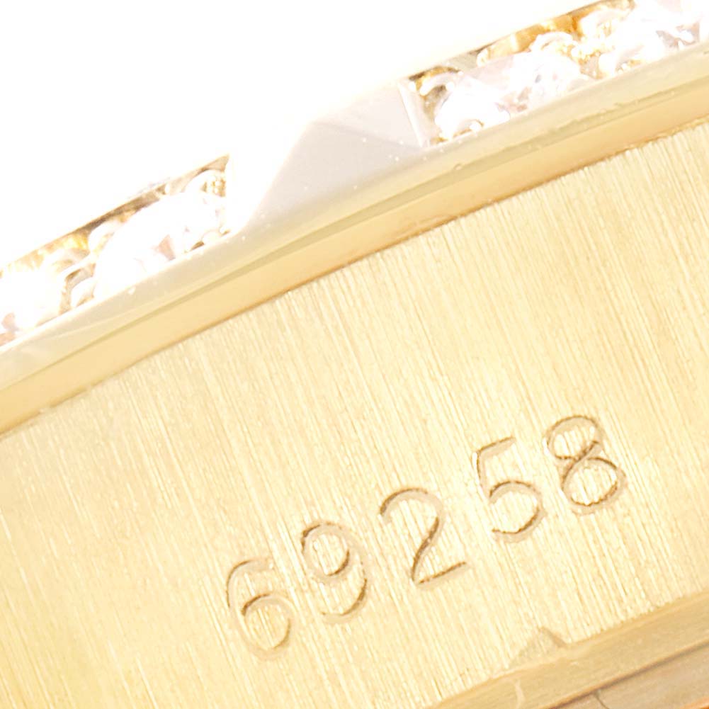 The image shows a close-up angle of the Rolex President 69258 Women
s Yellow Gold Champagne Dial 69258 Women
s Yellow Gold Champagne Dial model, focusing on the bezel with diamonds and the engraved model number 69258.