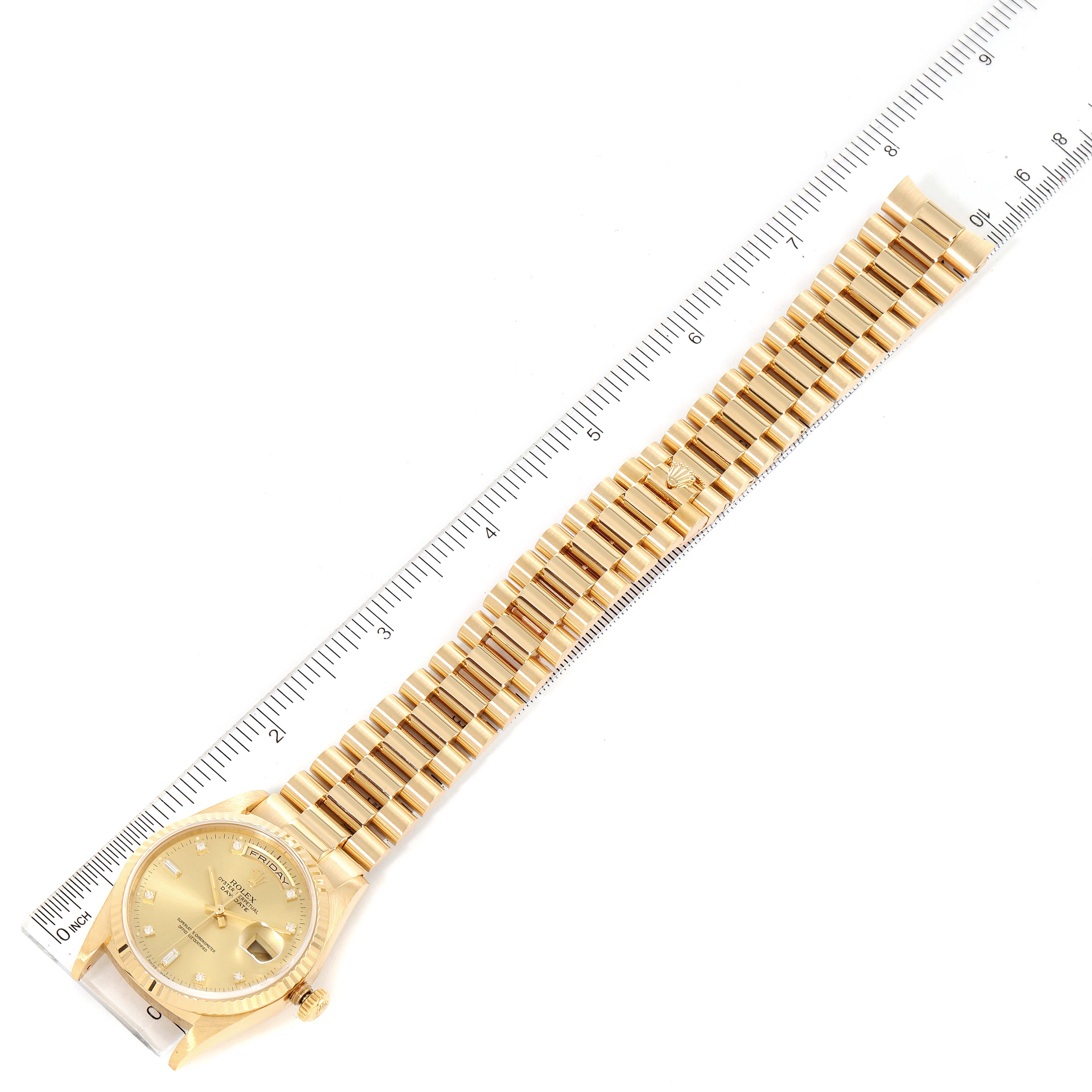 The image shows a gold Rolex President 18238 Men
s Yellow Gold Champagne Dial 18238 Men
s Yellow Gold Champagne Dial model watch laid flat alongside a measuring ruler.