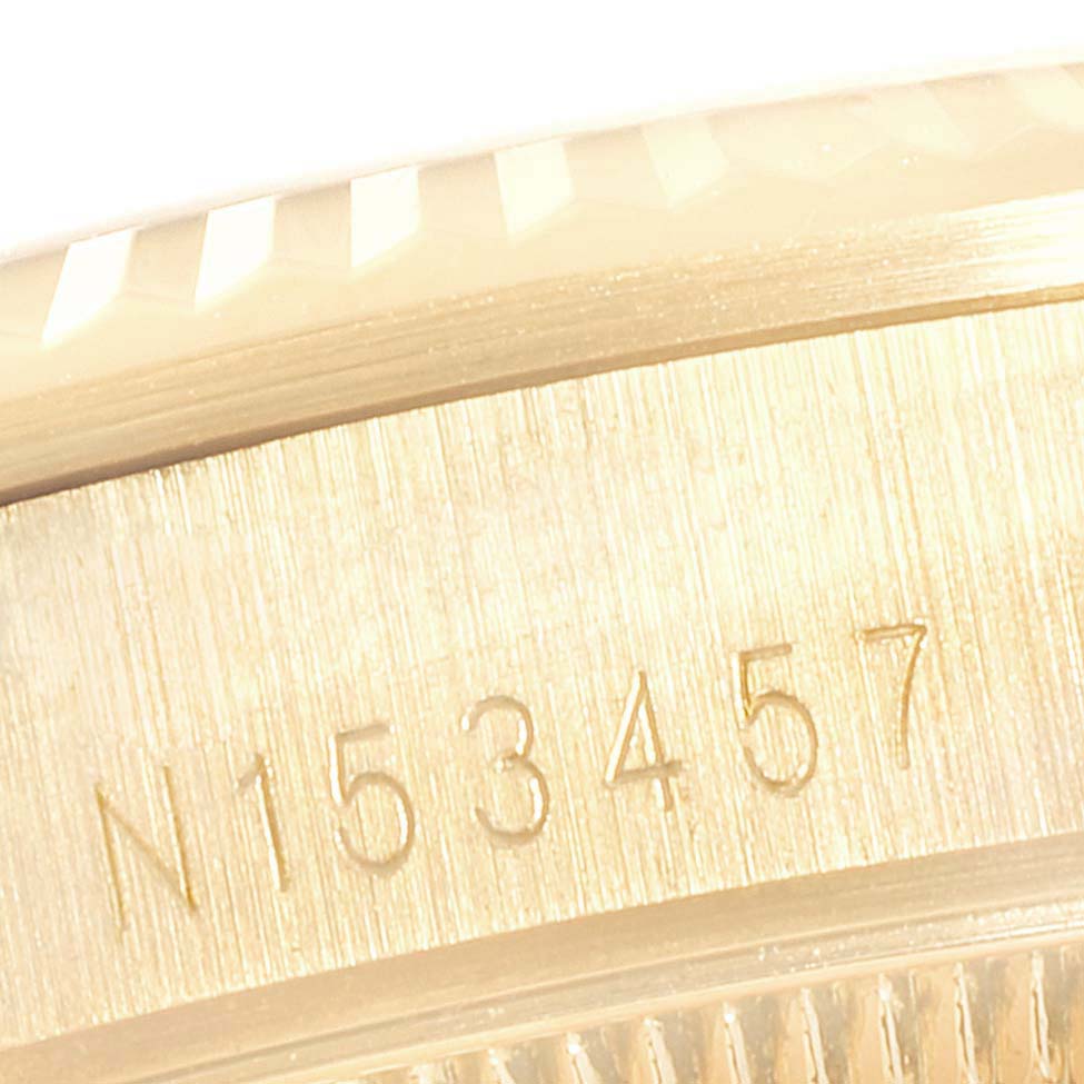 The image shows a close-up of the engraved serial number on the case of a Rolex President 68238  Women
s Yellow Gold Champagne Dial 68238  Women
s Yellow Gold Champagne Dial model watch.