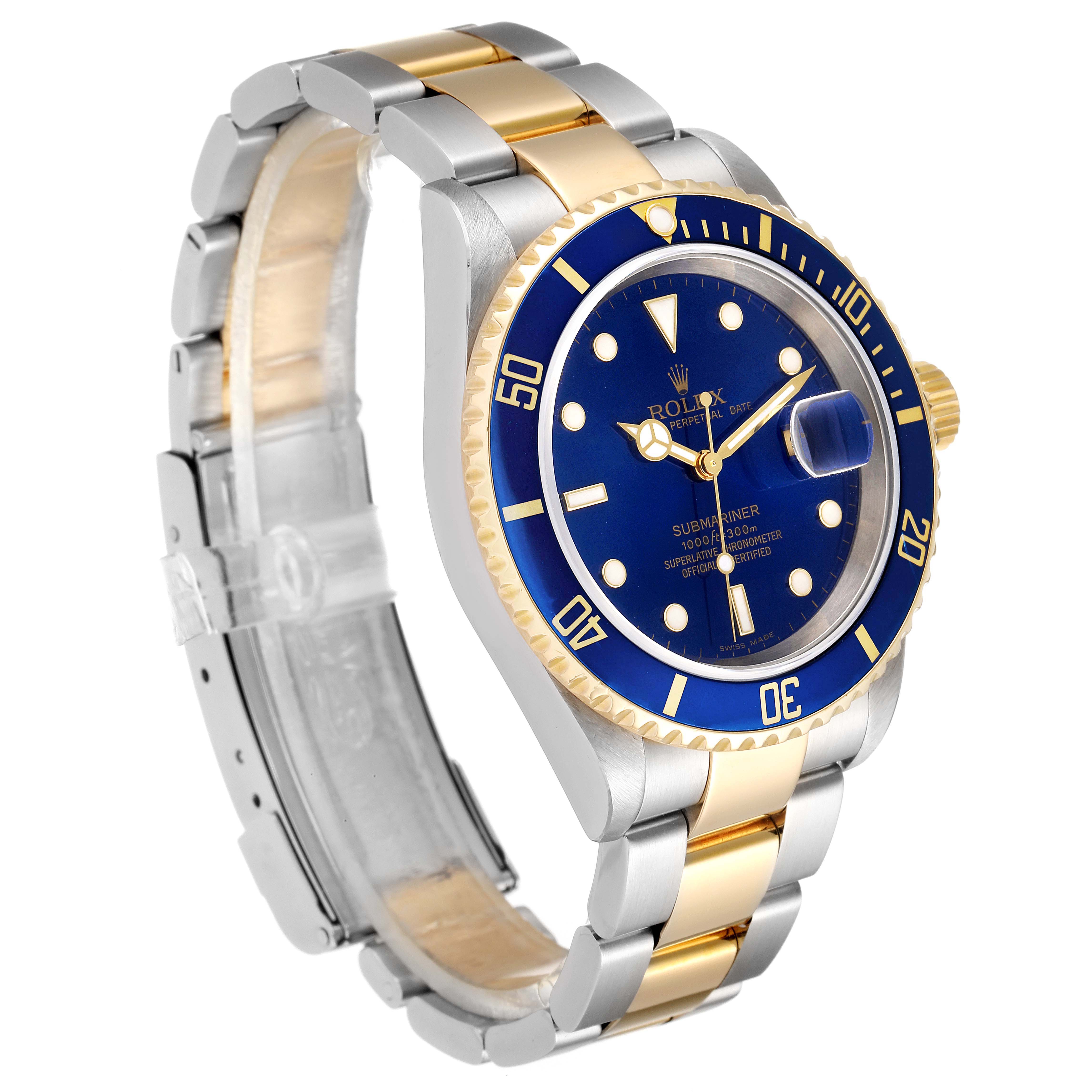 The image shows a side angle of a Rolex Submariner 16613 Men
s Steel and Gold (two tone) Blue Dial 16613 Men
s Steel and Gold (two tone) Blue Dial watch, highlighting its blue dial, bezel, and two-tone (gold and silver) bracelet.