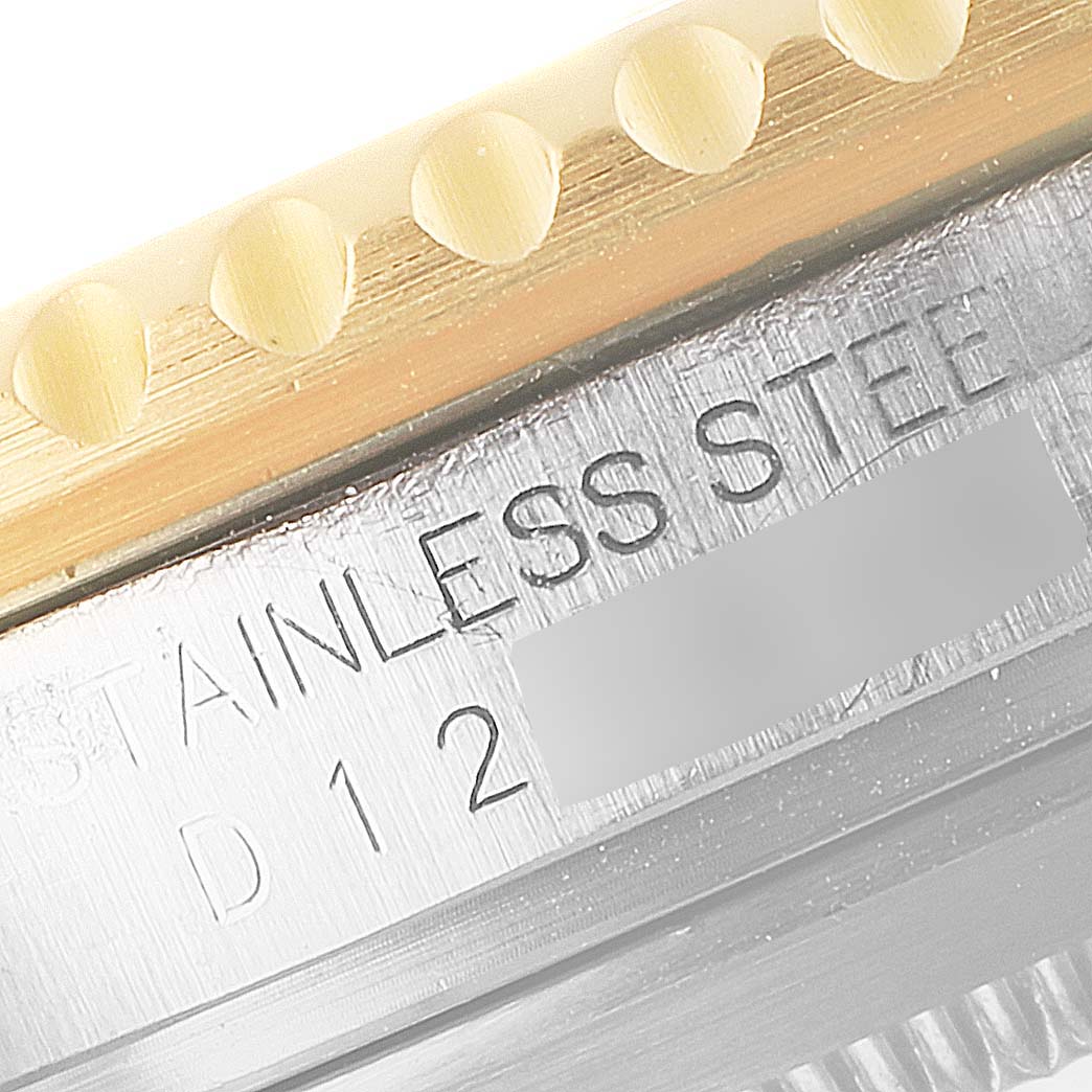 The image shows a close-up of the side engraving on a Rolex Submariner 16613 Men
s Steel and Gold (two tone) Blue Dial 16613 Men
s Steel and Gold (two tone) Blue Dial, highlighting the "STAINLESS STEEL" text.