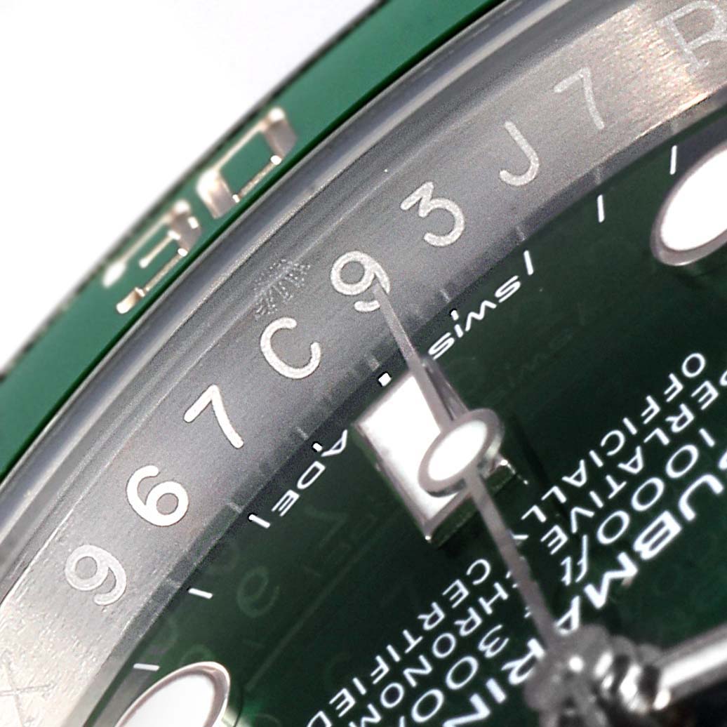 The image shows a close-up angle of the Rolex Submariner 116610LV  Men
s Stainless Steel Green Dial 116610LV  Men
s Stainless Steel Green Dial, focusing on the dial and part of the bezel with the 30-minute marker visible.